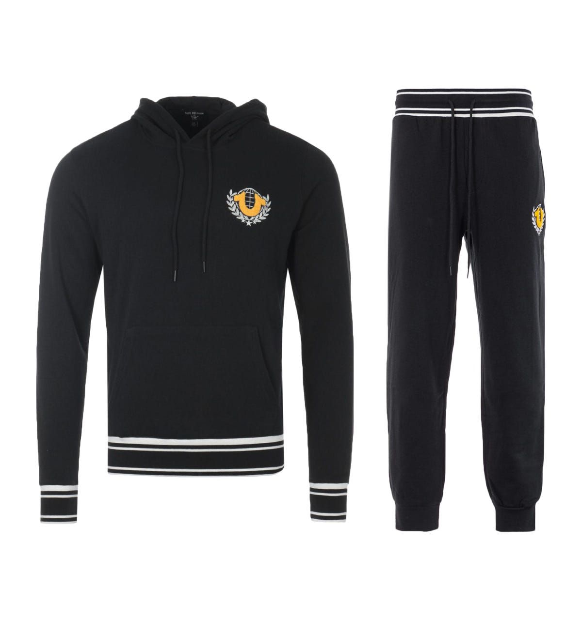 The Collegiate Crest Logo Tracksuit from True Religion boast their bold designs with supreme comfort. Both pieces have been crafted from a soft cotton blend providing comfort and breathability. The joggers are fitted with a drawstring waist and ribbed cuffs, whilst the hoodie is fitted with a drawstring hood, kangaroo pocket and ribbed trims. Both finished with iconic True Religion branding in a chenille effect and contrast stripe detailing.Regular FitCotton Blend CompositionHooded SweatshirtNatural Hand StitchingDrawstring JoggersChenille Effect LogosTrue Religion BrandingStyle & Fit:Regular FitFits True to SizeComposition & Care:60% Cotton40% PolyesterMachine Wash