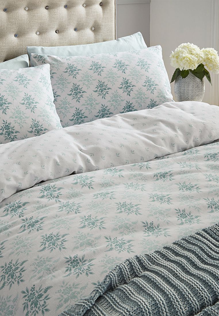 A beautifully soft brushed cotton floral design in soothing oxford grey. The calming floral motif repeats all-over in a delicate stamp-look diamond pattern to create an all-over tonal repeat. The simple reverse of a small-scale leaf and spot design is elegantly subtle.  100% brushed cotton. Made in Pakistan.