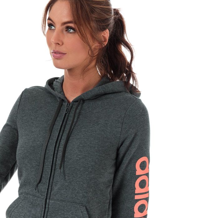 Womens adidas Essentials Linear Zip Hoody in dark grey heather - semi coral.<BR><BR>- Drawcord-adjustable hood.<BR>- Full zip fastening.<BR>- Long sleeves.<BR>- Kangaroo style pockets to front.<BR>- Ribbed cuffs and hem.<BR>- adidas linear logo printed at left sleeve.<BR>- Tonal back neck tape.<BR>- Slim fit.<BR>- Measurement from shoulder to hem: 23“ approximately.  <BR>- Main material: 52% Cotton  48% Recycled polyester.  Hood lining: 100% Cotton.  Machine washable.<BR>- Ref: EI0660<BR><BR>Measurements are intended for guidance only.