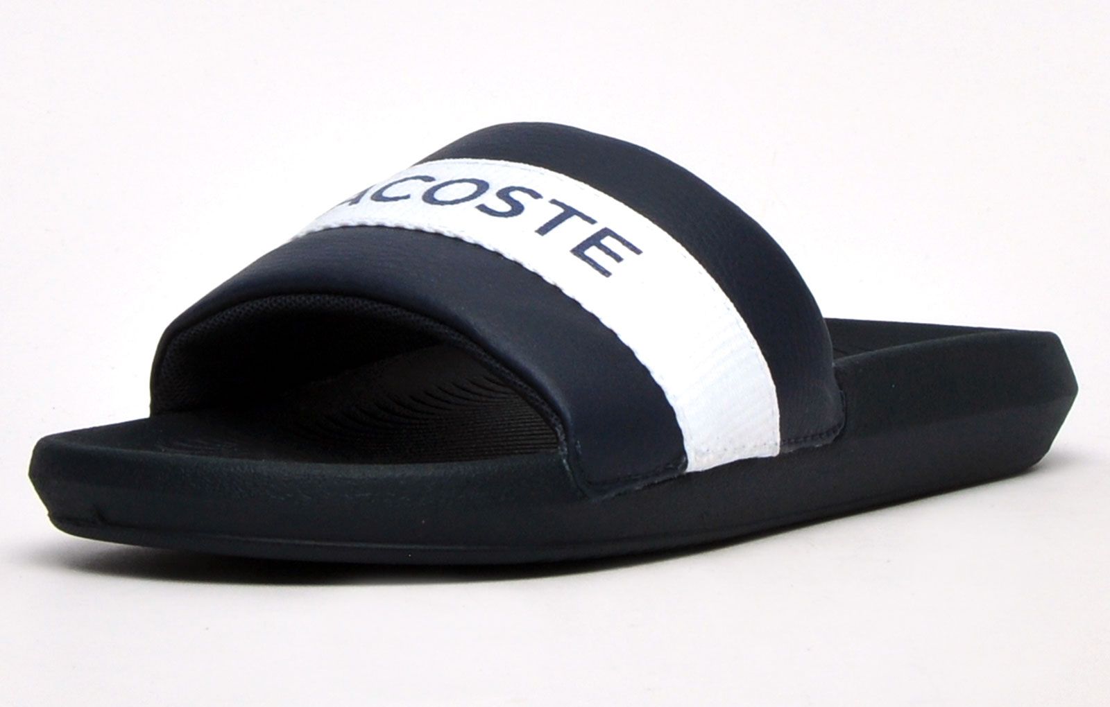 Step into on trend summer style with these mensCroco Slides from Lacoste. In a classic colourway, these designer sandals are delivered in a smooth synthetic upper with textile band stripe detailing across the forefoot foot strap. The super comfy moulded footbed delivers the perfect fit and feel while the grippy outsole will keep you sure and safe around the pool or in the shower. These designer slides are finished with eye catching Lacoste branding throughout just in case you want a sign of approval that youre wearing cool on-trend style this summer season 
 
 - Synthetic comfort upper
 - Comfort moulded footbed
 - Single strap construction
 - Grippy outsole
 - Slip on wear
 - Iconic Lacoste branding throughout
 Please Note: These slides are supplied poly bagged (without box)
 These Lacoste Slides are sold as B grades which means there may be some very slight cosmetic issues on the shoe and they come in a poly bag. There could be occasional issues with wrong swing tags being allocated to wrong shoes by Lacoste themselves which could result in some size confusion but you must take the size IN THE SHOE as the size that the shoe actually is ( not what is on the tag ). We have checked most of the shoes and in our opinion,all are practically perfect without any blemishes on them at all and in essence if the shoes did not have the letter B denoted on the swing tag you would presume these were perfect shoes. All shoes are guaranteed against fair wear and tear and offer a substantial saving against the normal high street price. The overall function or performance of the shoe will not be affected by any minor cosmetic issues. B Grades are original authentic products released by the brand manufacturer with their approval at greatly reduced prices. If you are unhappy with your purchase, we will be more than happy to take the shoes back from you and issue a full refund