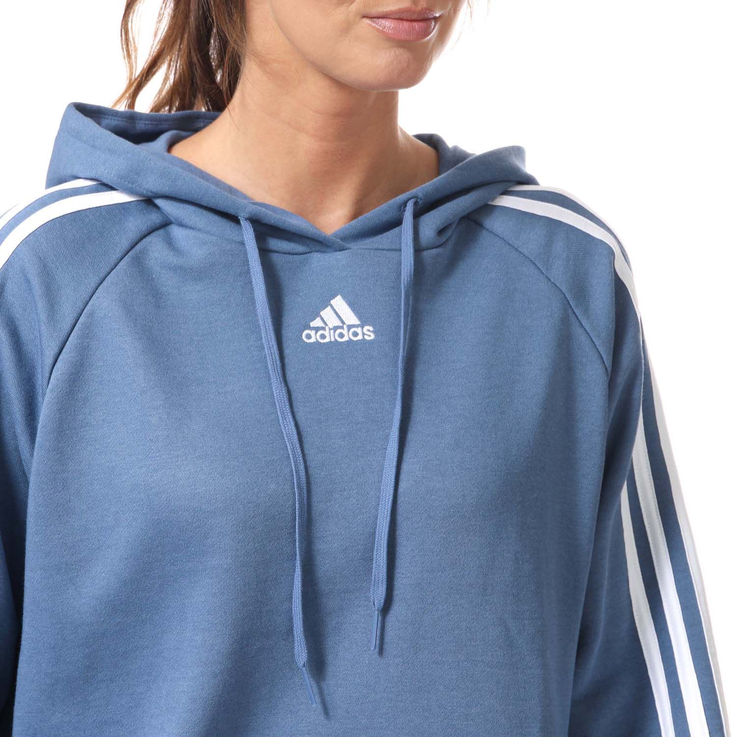 Womens adidas Essentials 3- Stripes Cropped Hoody in blue.- Drawcord-adjustable hood.- Long sleeves.- Ribbed cuffs and hem.- 3-Stripes down both arms.- adidas Badge of Sport logo on the chest.- Loose fit.- Main Material: 53% Cotton  36% Polyester (Recycled)  11% Rayon. Hood Lining: 100% Cotton. - Ref:GL1461