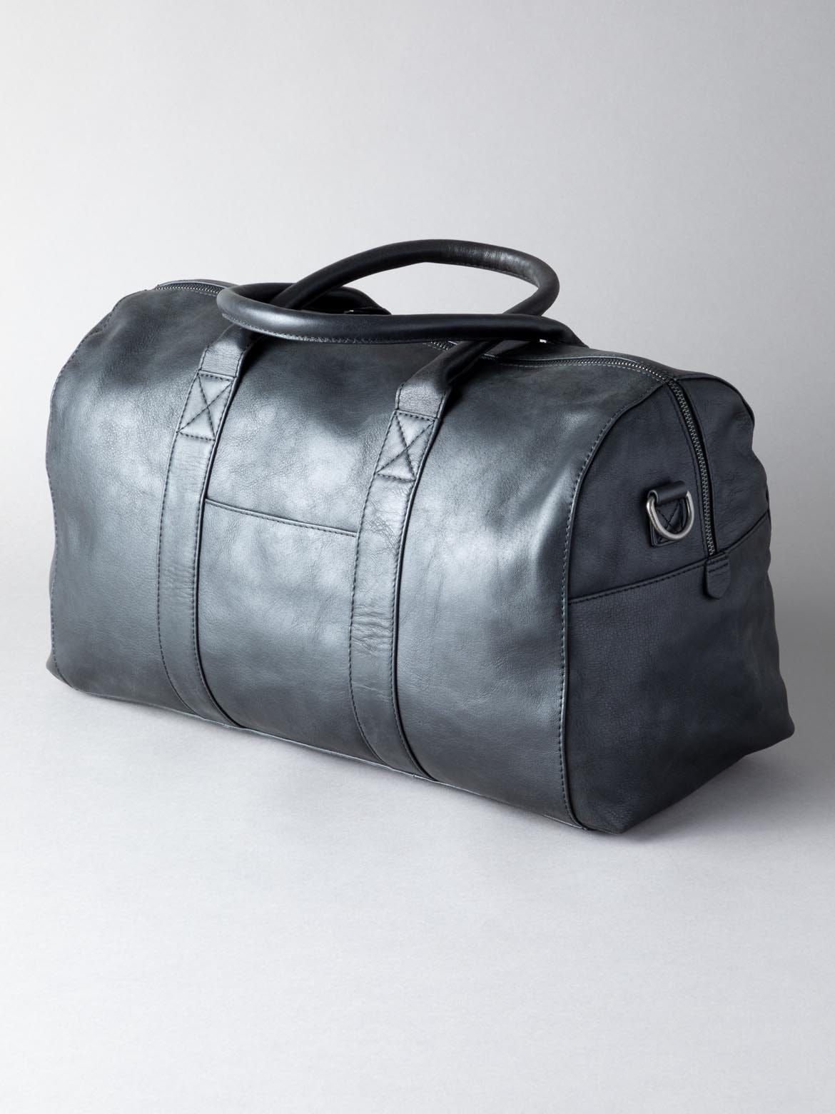 Explore in style with the Scarsdale Holdall in black. Crafted from premium natural leather, the holdall has been engineered for a rich, textured finish. With use it will develop a natural patina, so it will become even more uniquely yours over time � a mark of true quality. This leather holdall has been designed with comfort and durability at the forefront. The grab handles are padded so the bag can be carried with ease. The shoulder strap is fully adjustable and detachable with large, strong, clasp fittings to withstand the demands of everyday life. It is also lined throughout in a satin fabric.