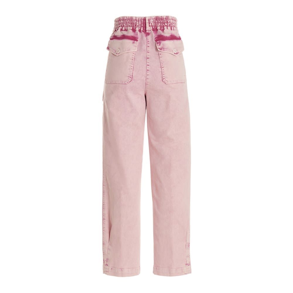 Délavé-effect cotton trousers with a zip and button fastening, pockets and an elasticized insert at the waist.