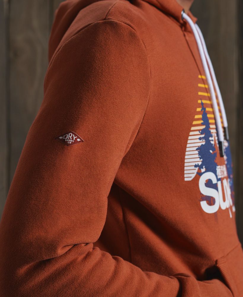 Relax in our Classic Logo Wilderness hoodie, featuring a fleece lining to provide you with an extra layer of warmth and comfort. Perfect for layering over a classic tee with jeans to complete a casual look this season.Slim fit – designed to fit closer to the body for a more tailored lookDrawstring hoodFleece liningFront pouch pocketRibbed cuffs and hemPrinted Superdry logo graphic