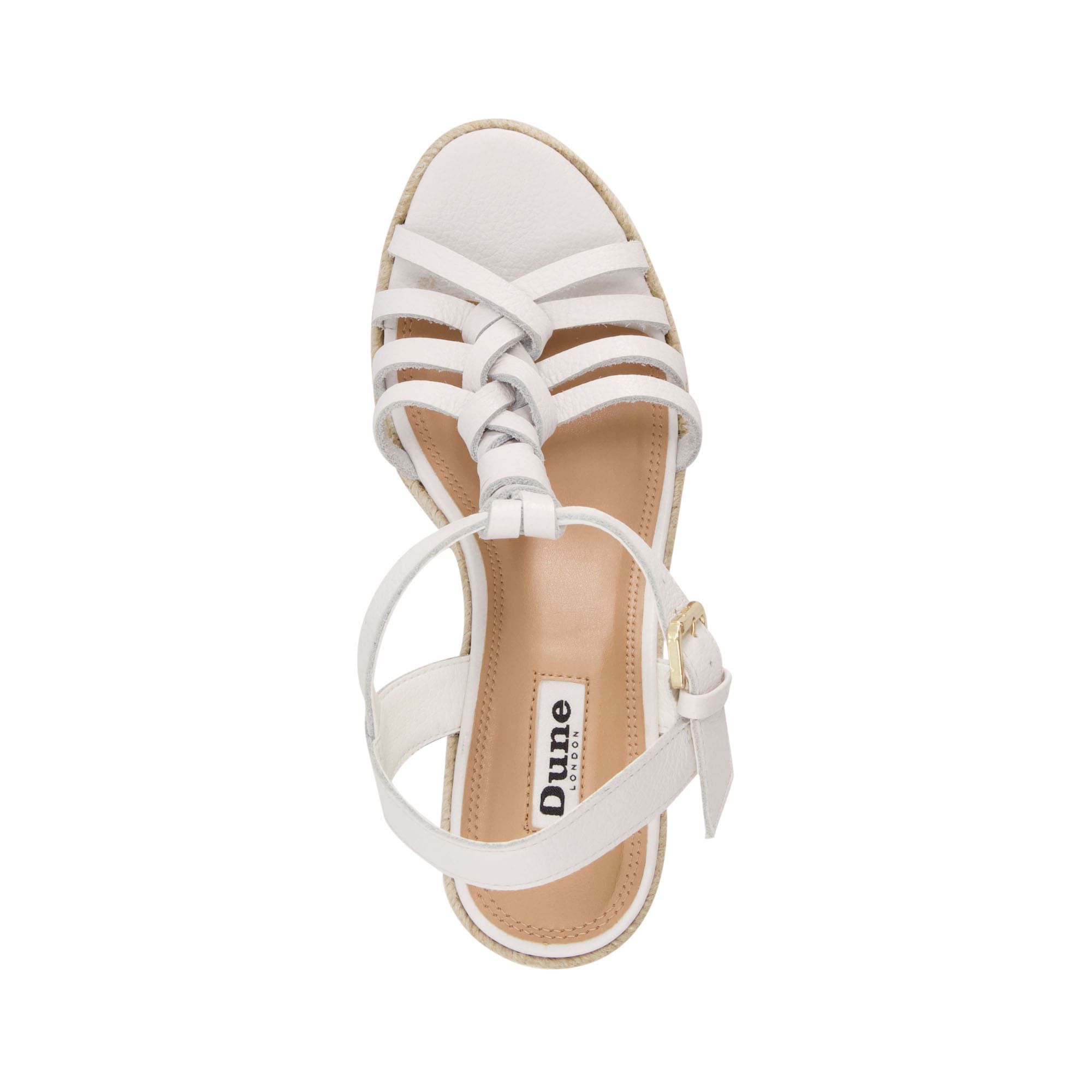 Reinvigorate your Summer wardrobe. The plaited leather twists on these sandals enhance the luxe artisan feel. They rest on natural raffia high wedges, grounded with rubber for grip.