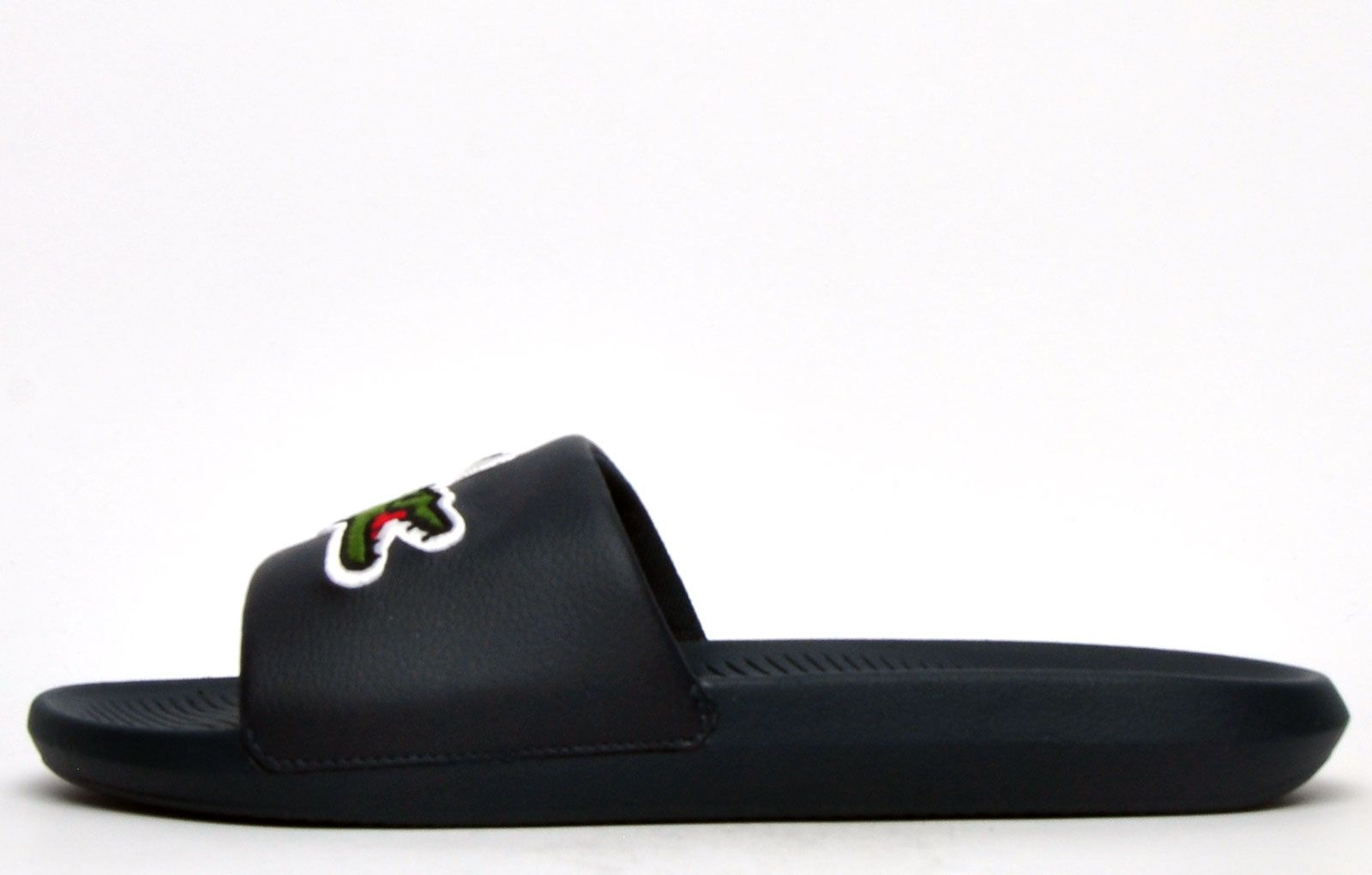 Step into eye catching summer style with these mens Croco Slides from Lacoste. In a bang on trend colourway, these designer sandals are delivered in a smooth synthetic upper with croc detailing across the forefoot foot strap. The comfy footbed moulds to your feet, delivering the perfect fit and feel while the grippy outsole will keep you sure and safe around the pool or in the shower. These designer slides are finished with eye catching Lacoste branding throughout just in case you want a sign of approval that youre wearing cool classic style this summer season 
 - Comfort moulded footbed
 - Single Strap Detail Over Foot
 - Grippy outsole
 - Slip on wear
 - Iconic Lacoste branding throughout
 Please Note: These Lacoste Sliders are sold as B grades which means they have some slight cosmetic issues on the shoe and they come poly bagged. All shoes are guaranteed against fair wear and tear and offer a substantial saving against the normal high street price. The overall function or performance of the shoe will not be affected by cosmetic issues. B Grades are original authentic products released by the brand manufacturer with their approval at greatly reduced prices. If you are unhappy with your purchase we will be more than happy to take the shoes back from you and issue a full refund.