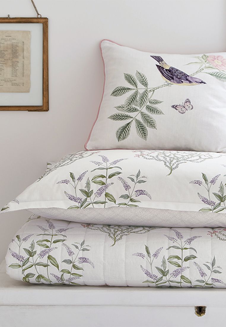 Create a sanctuary of calm with this 100% cotton bedding set from Sanderson Options. Adorned with an all-over delicate floral motif placed on an Ivory ground, the duvet, which is available in four sizes, has a small-scale textured geometric reverse. Oxford pillowcases are included in sets. Build layers of comfort with a quilted bedspread in the same design as the duvet and finish with an accessory cushion, printed with a floral, bird and butterfly design. Embroidered accents add textural detail to the cushion which comes in a lovely Foxglove colourway. Fibre Filled, Made in China.