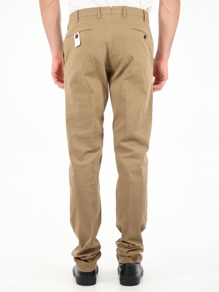 Superslim fit beige trousers made of cotton. They feature front zip and button closure, belt loops, two side pockets and two back pockets with button.The model is 184 cm tall and wears a size 48