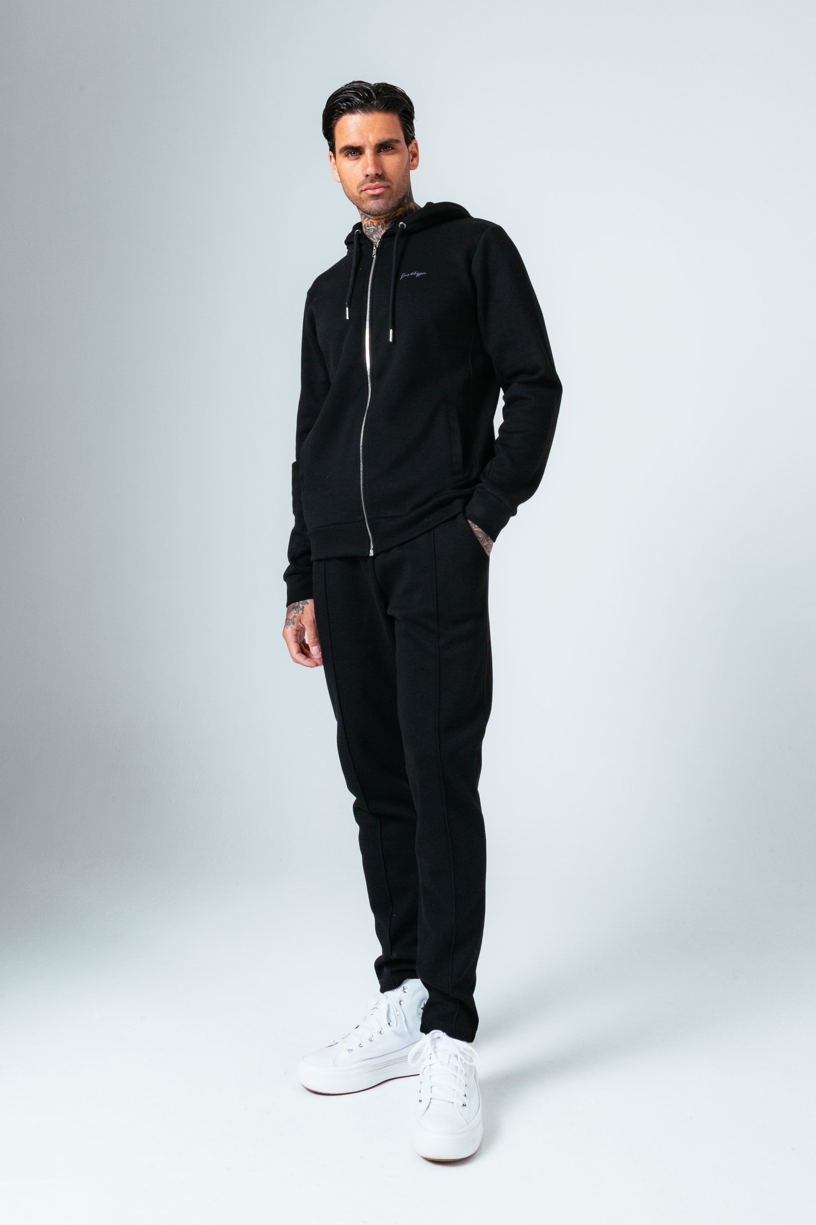 The HYPE. Black Pique Men's Jogger pairs with the HYPE. Black Pique Zip Men's Hoodie. Designed in our slim jogger shape in a 50% cotton and 50% polyester pique fabric base for the ultimate comfort and breathable space. With stitched pleat detailing, an elasticated waistband and stitched hems. Machine washable.