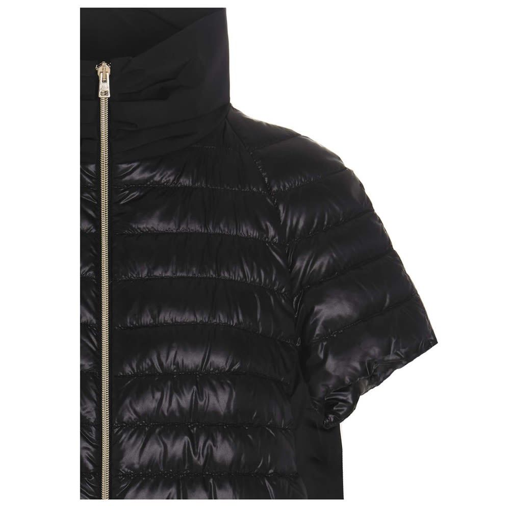 Ultralight nylon puffer jacket with a full zip closure and a high neck. Unpadded back.