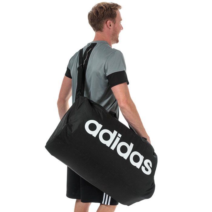 adidas Linear Core Duffel Bag - Large in black - white.<BR><BR>- Main compartment with dual zip fastening.<BR>- Elasticated inner slip compartment for shoes or laundry.<BR>- Zipped front pocket.<BR>- Mesh slip pocket to side.<BR>- Adjustable webbing shoulder strap with padding.<BR>- Webbing carry handles with padding.<BR>- adidas linear logo to front.<BR>- 75.6 litre capacity.<BR>- Dimensions: 34cm (H) x 65cm (W) x 27cm (D) approximately.<BR>- Main material: 51% Recycled polyester  49% Polyester.  Lining: 100% Polyester.  Padding: 100% Polyethylene.  Sponge clean only.<BR>- Ref: DT4824<BR><BR>Measurements are intended for guidance only.