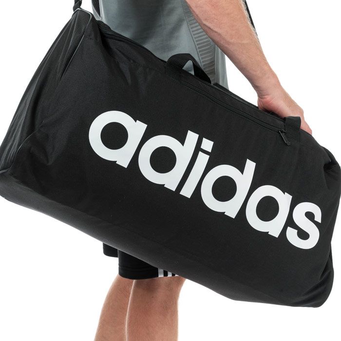 adidas Linear Core Duffel Bag - Large in black - white.<BR><BR>- Main compartment with dual zip fastening.<BR>- Elasticated inner slip compartment for shoes or laundry.<BR>- Zipped front pocket.<BR>- Mesh slip pocket to side.<BR>- Adjustable webbing shoulder strap with padding.<BR>- Webbing carry handles with padding.<BR>- adidas linear logo to front.<BR>- 75.6 litre capacity.<BR>- Dimensions: 34cm (H) x 65cm (W) x 27cm (D) approximately.<BR>- Main material: 51% Recycled polyester  49% Polyester.  Lining: 100% Polyester.  Padding: 100% Polyethylene.  Sponge clean only.<BR>- Ref: DT4824<BR><BR>Measurements are intended for guidance only.