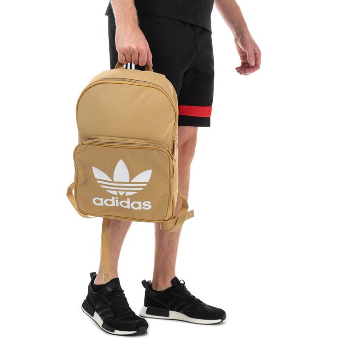 adidas Originals Classic Trefoil Backpack in raw sand.<BR><BR>- One main zip compartment.<BR>- Front zip pocket.<BR>- Inner laptop compartment.<BR>- Padded shoulder straps with zigzag stitching.<BR>- Webbing carry handle to top.<BR>- Trefoil branding to front.<BR>- Dimensions: 42cm (H) x 28.5cm (W) x 15cm (D) approximately.<BR>- Main material: 100% Polyester.  Lining: 100% Polyester.  Padding: 100% Polyethylene.<BR>- Ref: DW5186<BR><BR>Measurements are intended for guidance only