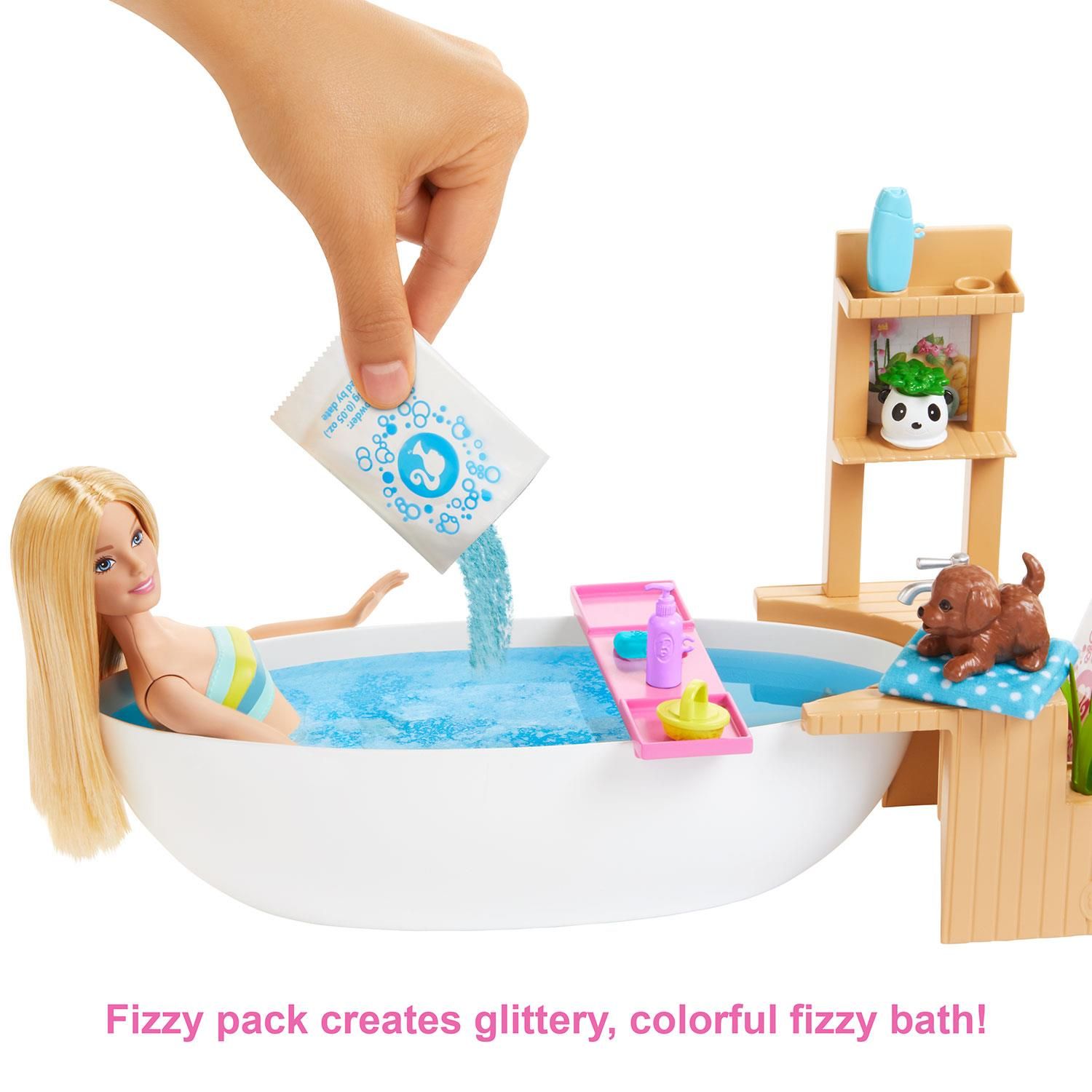 Barbie Fizzy Bath Doll & Playset, Blonde with Tub, Fizzy Powder, Puppy & More

Barbie doll knows the way to be one best is to give yourself the best care This spa-themed playset celebrates one of her favourite ways to recharge: a fizzing bath. It comes with a Barbie doll, a puppy, a spa tub, and accessories to play out a real fizzy bath. Simply fill the tub with water, place the Barbie doll inside and add one of the five included glittery fizz packs to see the water bubble, just like in a real spa Barbie doll can relax with accessories that include a tub tray, bath products, a loofah, a back brush, and a towel. The spa is calming, too, with a wood-inspired frame complete with a panda planter. There's lots of space for puppies to sit, plus spots to store the accessories. Some pieces have a handle the doll can hold to encourage easy role-play fun. The Barbie doll wears a swimsuit with a wrap-around towel and features extra flexibility for realistic posing and active play.

Features:

Kids can practice self-care as they help Barbie doll recharge with this spa-themed playset that lets them play out a classic moment -- a glittery, fizzy bath.
​The set includes a Barbie doll wearing a swimsuit, her puppy, a bathtub, a spa frame, 5 packs of fizzy powder and accessories to help play out a relaxing bath.
​To start the spa-like action, fill the tub with water, place the doll inside and add one of the glittery fizz packs -- the water will change colour, bubble, and foam for a life-like experience.
​Bath accessories expand the storytelling opportunities -- handles on some of the pieces make it easier for kids to role-play; place the products and brushes on the bath tray or store them on the spa frame.
​The wood-inspired frame has a plug-and-play design to hold accessories in place for active play and easy cleanup; plants add realistic calming touches.

Package Includes: Barbie Fizzy Bath Doll & Playset