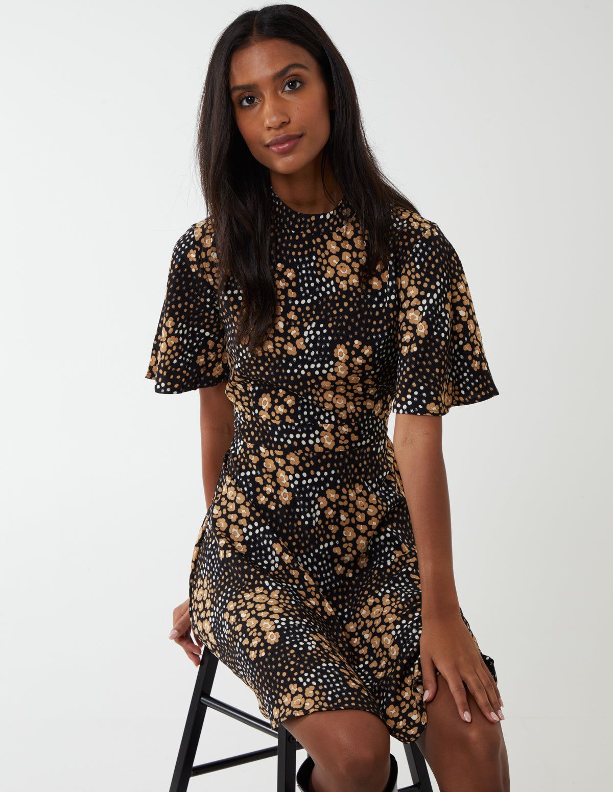 We have the perfect dress for you to wear at fancy dinner party or a night out with your friends. It has angel sleeves, an adorable floral print, a high neckline and it looks great with block heel shoes!