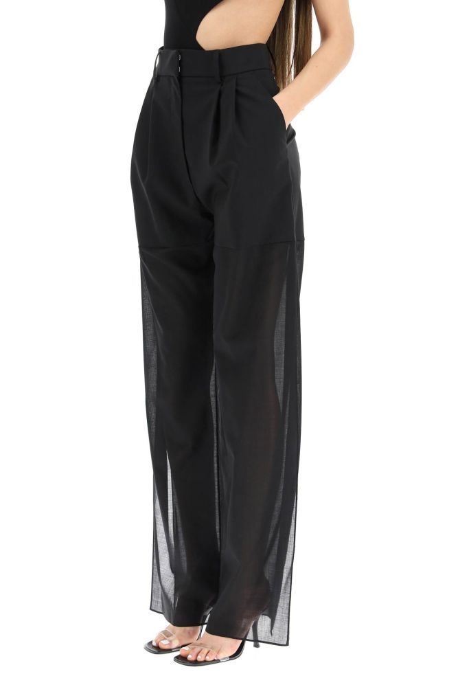 A.W.A.K.E. Mode high-waisted trousers in stretch virgin wool, featuring wool-blend muslin leg and deep side slits. Double dart at front, concealed zip and double-hook closure, slash pockets. Loose fit. The model is 177 cm tall and wears a size FR 36.