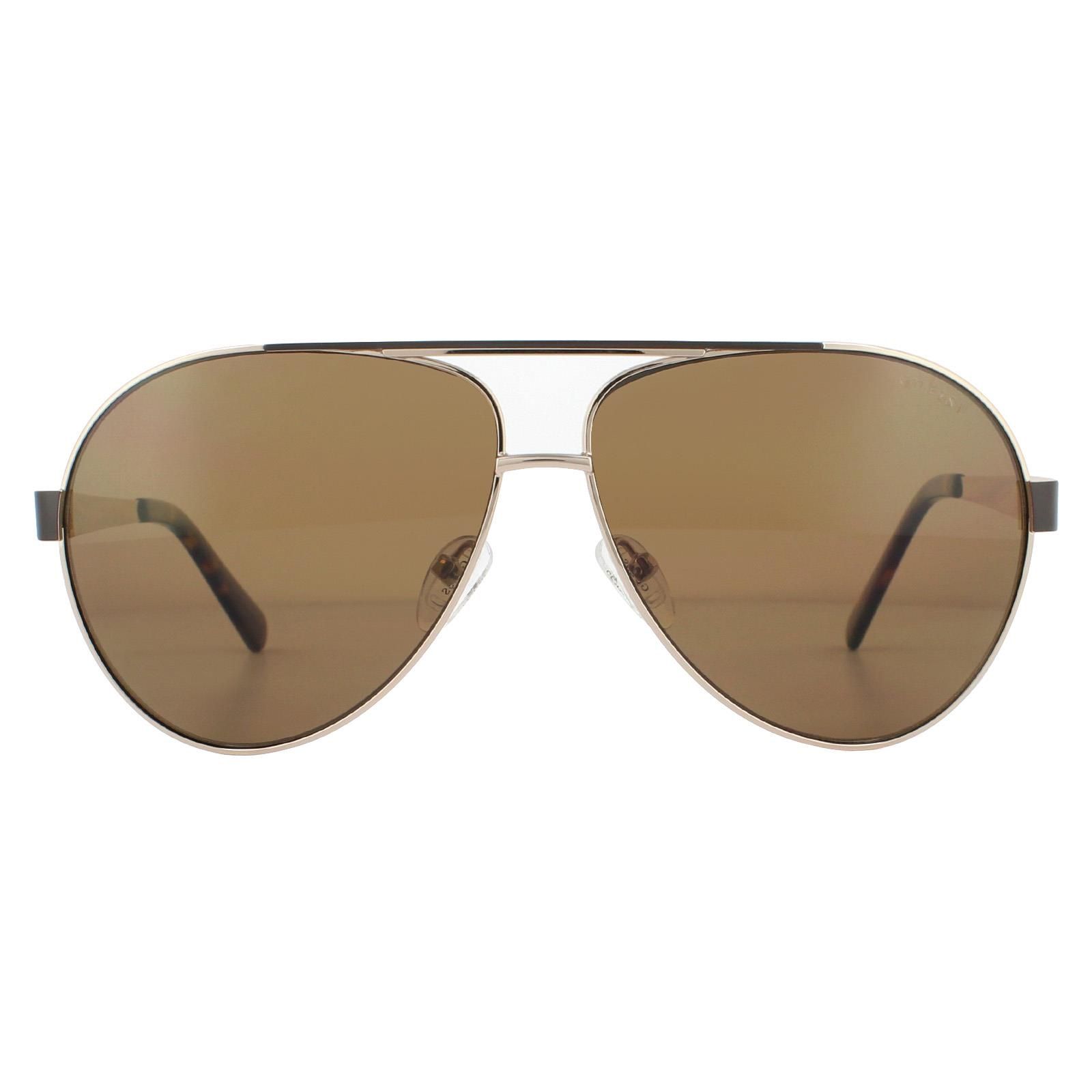 Guess Sunglasses GU6969 32H Gold Brown Polarized are a large lens aviator style with cut-out Guess G logo on the temples. The temple colours match the top brow bar for a unique two-tone effect.