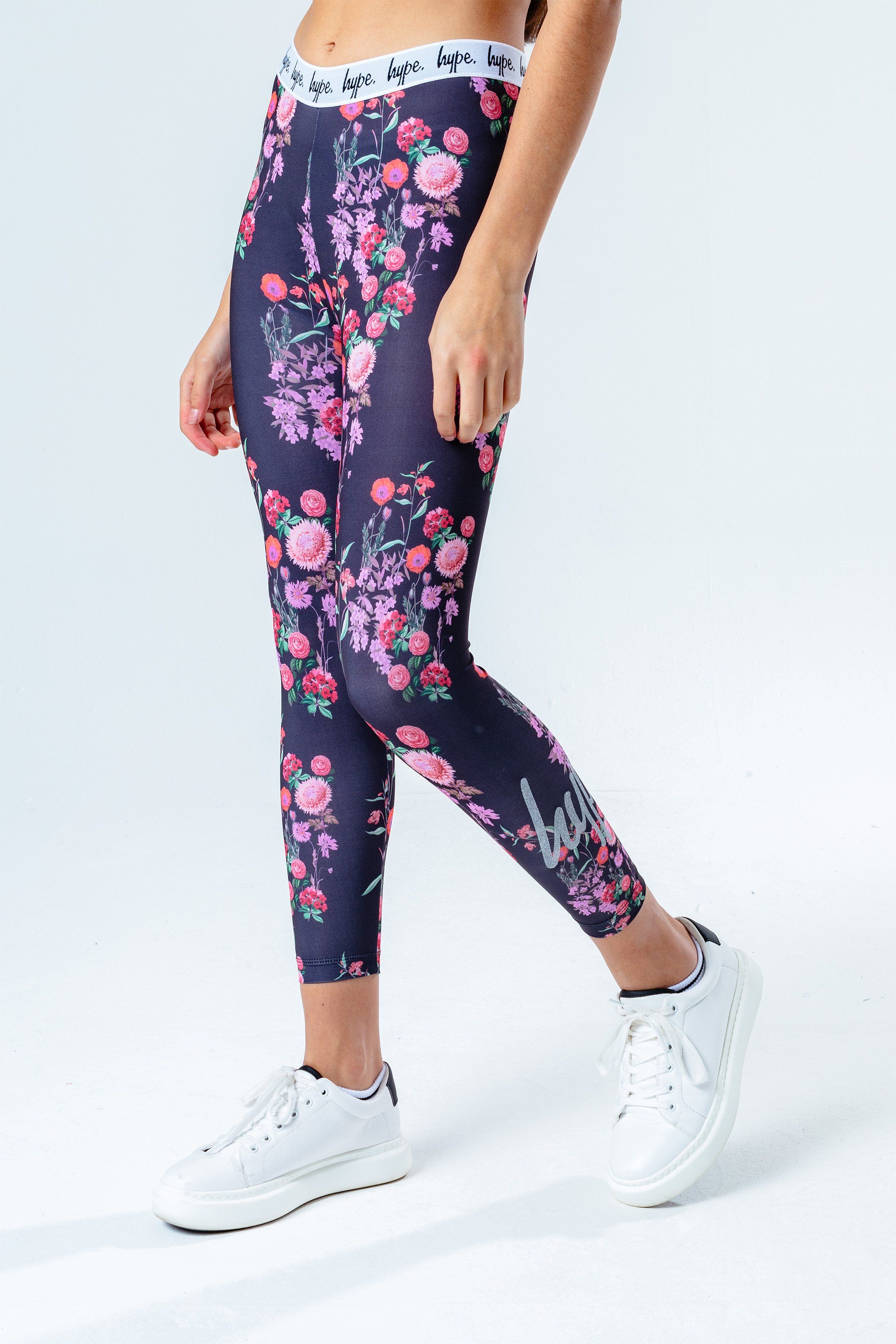 The HYPE. Ditsy Floral Kids Leggings are perfect to add to your everyday rotation. In a pink, peach, green and black colour palette in our standard kids legging shape. With an embossed monochrome elasticated waistband in a micro poly fabric for the ultimate comfort. Boasting an all-over floral print. Finished with the iconic HYPE. script logo in a  glitter transfer. Wear the matching kids crop tee to complete the look. Machine wash at 30 degrees.