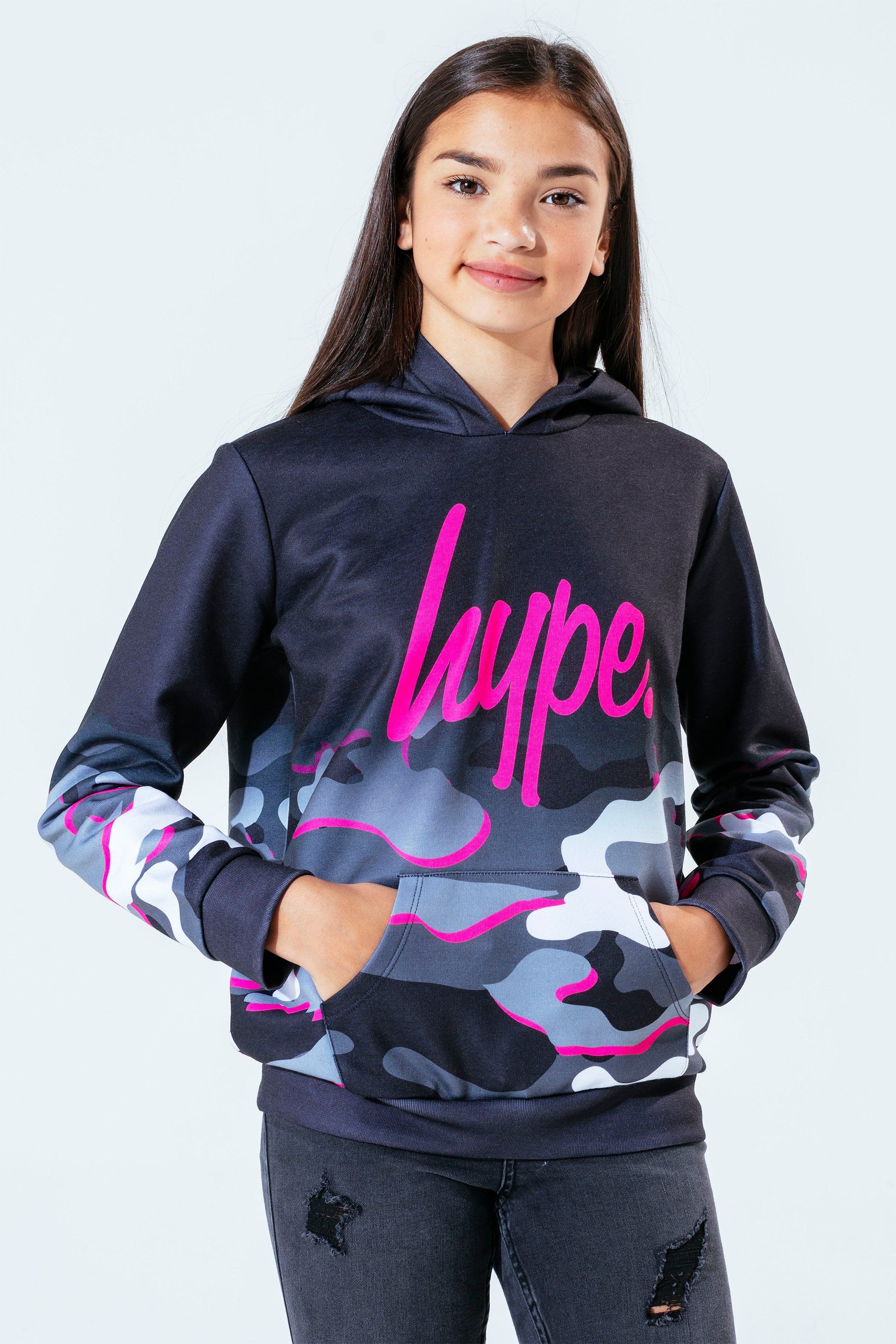 The Hype. pink line camo girls hoodie features our signature camo print in a monochrome, grey and pink injection colour palette. In a 95% polyester and 5% cotton fabric base for supreme comfort in our standard kids pullover shape, highlighting a fixed hood, kangaroo pocket and fitted hem and cuffs. Finished with the iconic HYPE. script logo in a holographic fabric. Wear with cycle shorts for an on-trend look. Machine wash at 30 degrees.