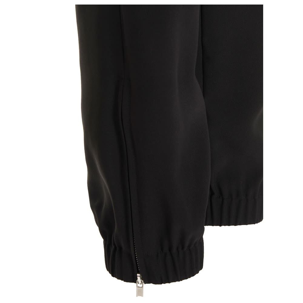 'Track' viscose cady pants with a drawstring at the waist and a zip at the leg bottoms.