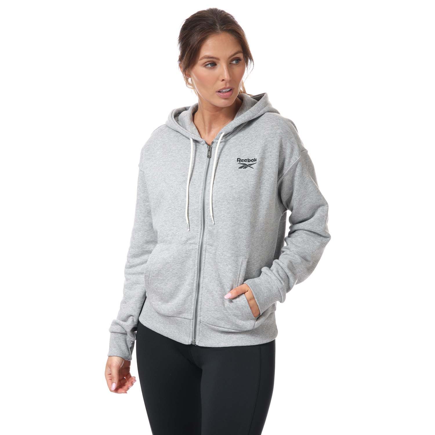 Womens Reebok Identity Zip- Up Track Top in grey heather.- Drawcord-adjustable hood.- Long sleeves with ribbed cuffs.- Full zip fastening.- Kangaroo pocket.- Ribbed hem.- Small logo.- Oversize fit.- Main Material: 80% Cotton  20% Polyester (Recycled). Rib Part: 95% Cotton  5% Elastane. - Ref:GI6607