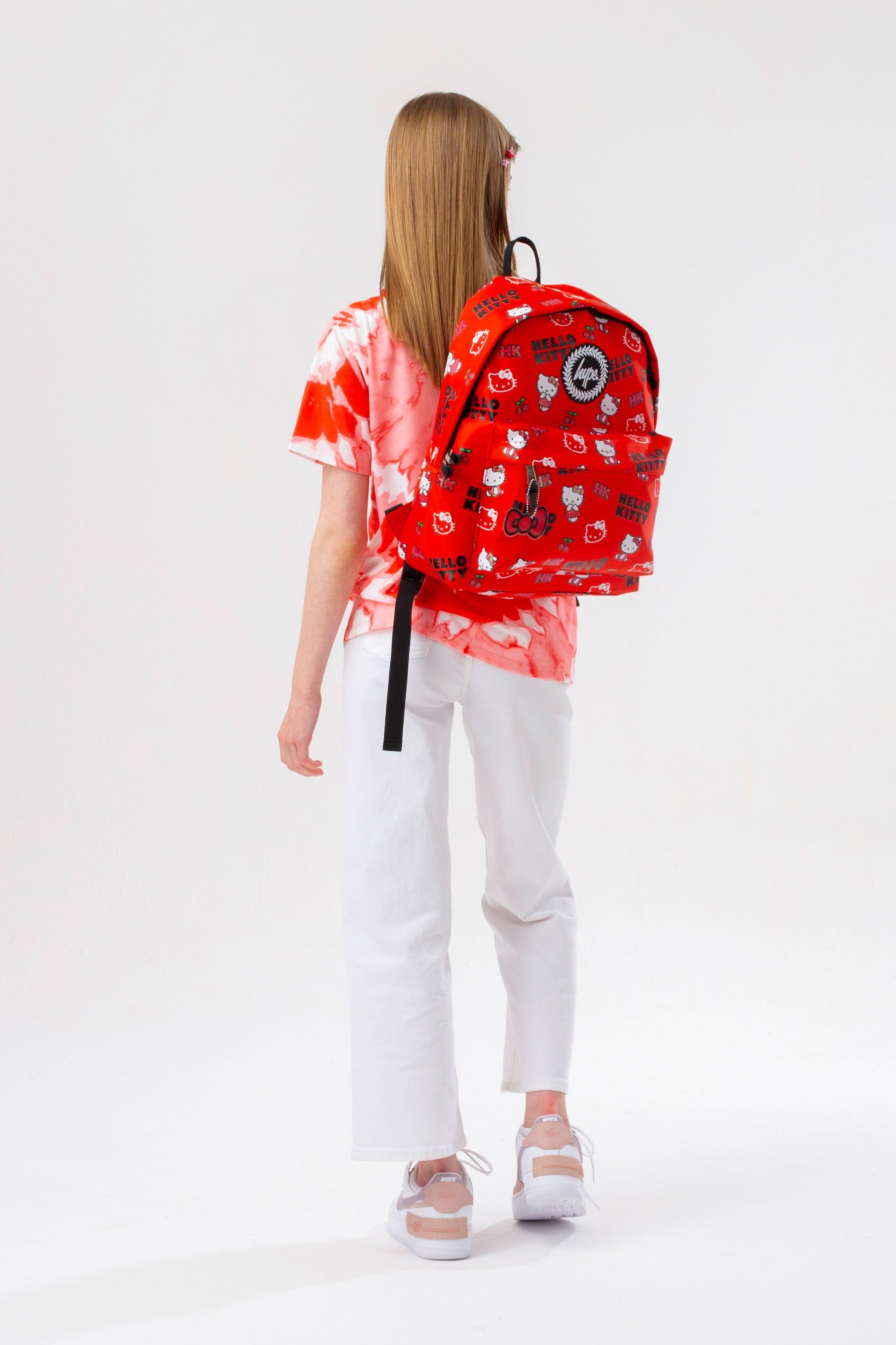 You can never have too many backpacks! Meet the HYPE. X Hello Kitty Mini Print Backpack, part of our brand new collaboration collection and your new go-to accessory. Designed in our standard backpack shape in a red nylon fabric, boasting screen print detail, navy glitter, bow charm detail, and the iconic HYPE. crest logo. 