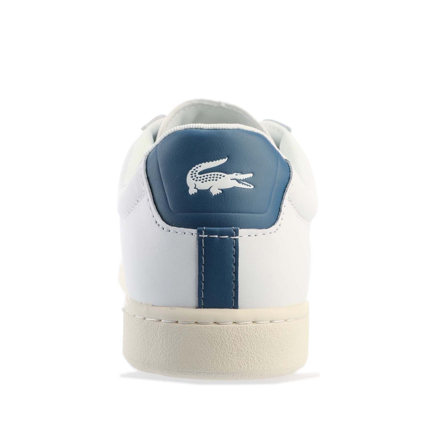 Mens Lacoste Carnaby Leather Accent Heel Trainers in white - dark blue.- Premium leather upper.- Lace up fastening with comfortable flat laces.- Padded collar and tongue.- Piqué-inspired mesh lining.- Removable Ortholite sockliner for comfort and odour control.- Rubber cupsole with stitching.- Lacoste lettered branding at tongue.- Contrast heel patch with printed crocodile.- Embroidered crocodile to side.- Leather upper  Textile lining  Synthetic sole.- Ref: 7-43SMA0017X96