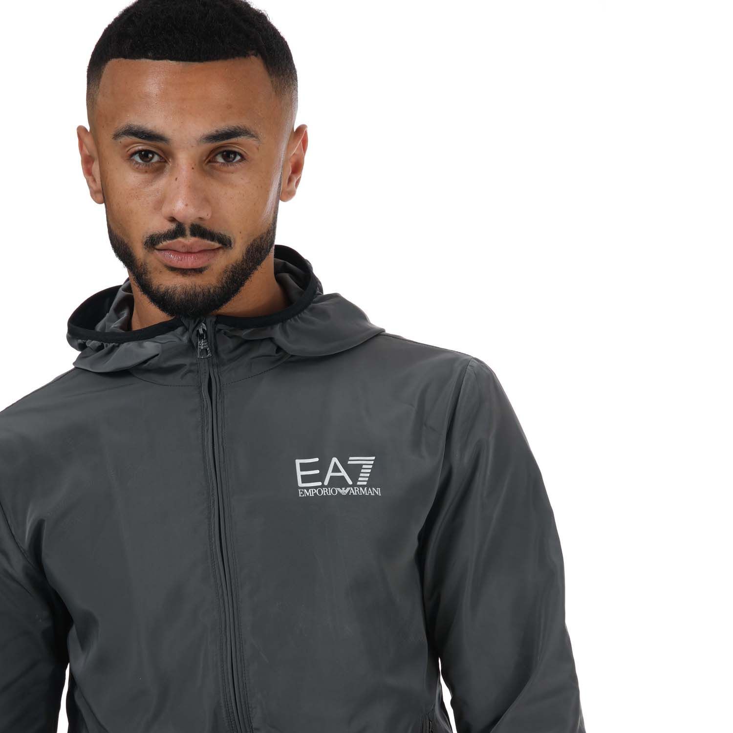 Mens Emporio Armani EA7 Fundamental Sporty Blouson Jacket in grey.- Attached drawstring hood.- Long sleeves.- Full zip fastening.- Two zipped front pockets.- Elasticated cuffs.- Contrasting EA7 logo on the chest.- 100% Polyester.- Ref: 8NPB04NN7Z1977