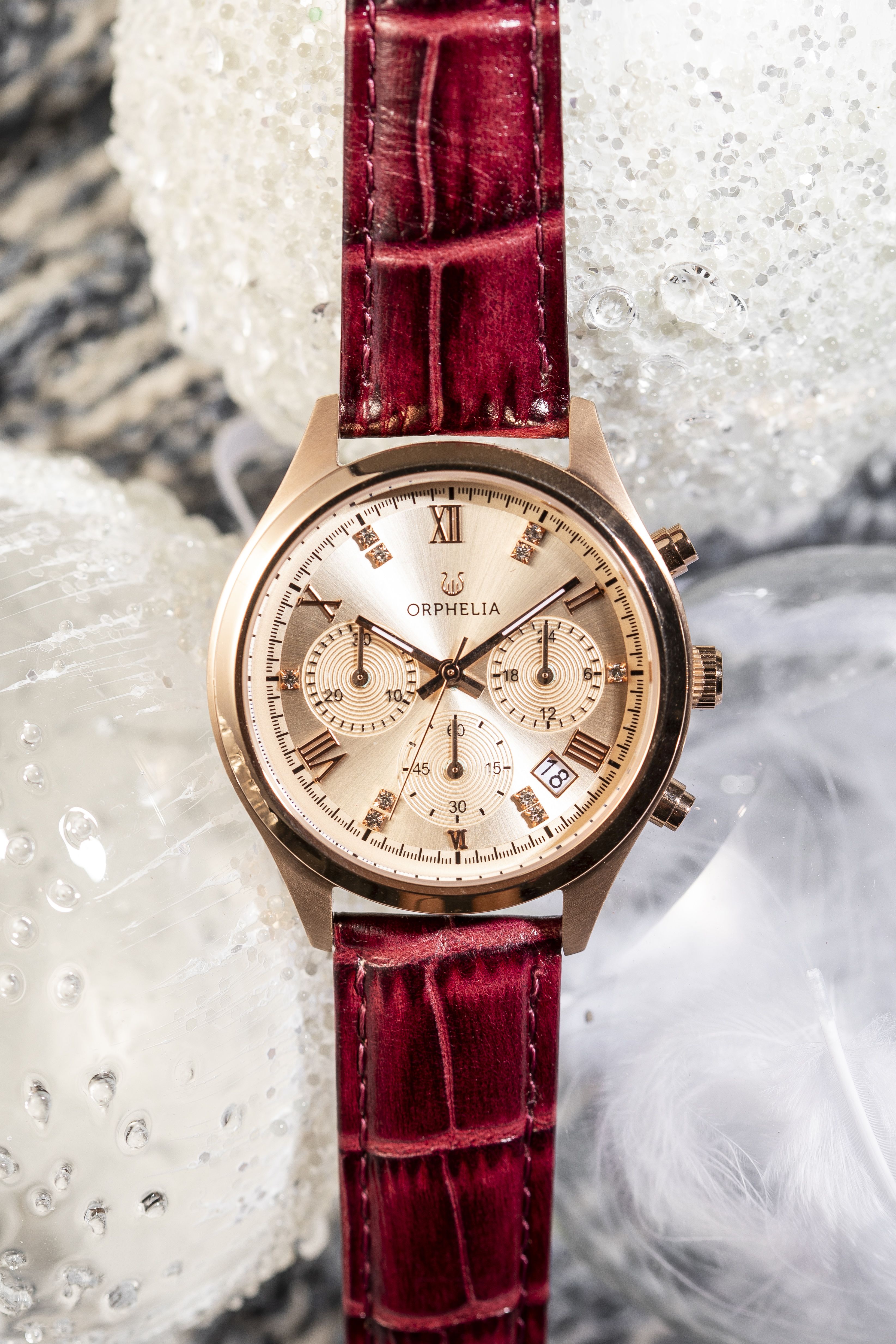 This Orphelia Regal Chronograph Watch for Women is the perfect timepiece to wear or to gift. It's Pink 38 mm Round case combined with the comfortable Burgundy Leather watch band will ensure you enjoy this stunning timepiece without any compromise. Operated by a high quality Quartz movement and water resistant to 5 bars, your watch will keep ticking. MODERN LUXURY DESIGN: This Orphelia Regal Chronograph watch with a Miyota Japanese Quartz movement includes a date display. The dial is setted with beautifull stones with Roman numeral. Some extra features  are 24 hour display and Luminous Hands. This watch will give you a Luxery look. PREMIUM QUALITY: By using high-quality materials, Glass: Mineral Glass, Case material: Stainless steel, Bracelet material: Crocodile-embossed Leather- Water resistant: 5 bars COMPACT SIZE: Case diameter: 38 mm, Height: 10 mm, Strap- Length: 22 cm, Width: 17 mm. Due to this practical handy size, the watch is absolutely for everyday use-Weight: 44 g