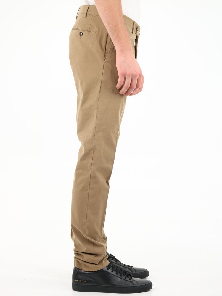 Superslim fit beige trousers made of cotton. They feature front zip and button closure, belt loops, two side pockets and two back pockets with button.The model is 184 cm tall and wears a size 48