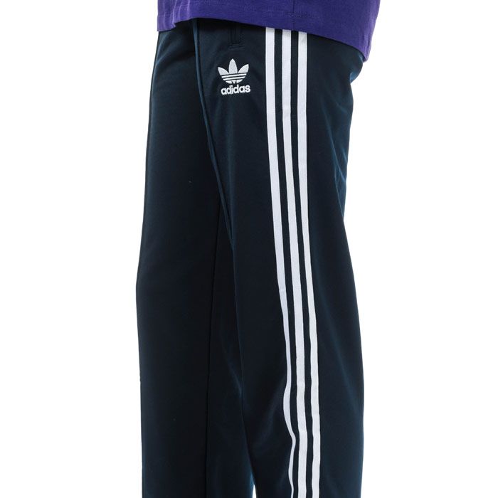 Womens adidas Originals Firebird Track Pants in collegiate navy.<BR><BR>- Iconic track pants crafted in smooth  shiny tricot.<BR>- Elasticated waist with inner drawcord.<BR>- Zipped front pockets.<BR>- Pintuck seams at front legs.<BR>- Ankle zips for easy on - off.<BR>- Applied 3-Stripes to legs.<BR>- Embroidered Trefoil logo at left thigh.<BR>- Regular fit.<BR>- Inside leg measures 32in approximately.  <BR>- Main material: 100% Recycled polyester.  Machine washable.<BR>- Ref: ED7509<BR><BR>Measurements are intended for guidance only.