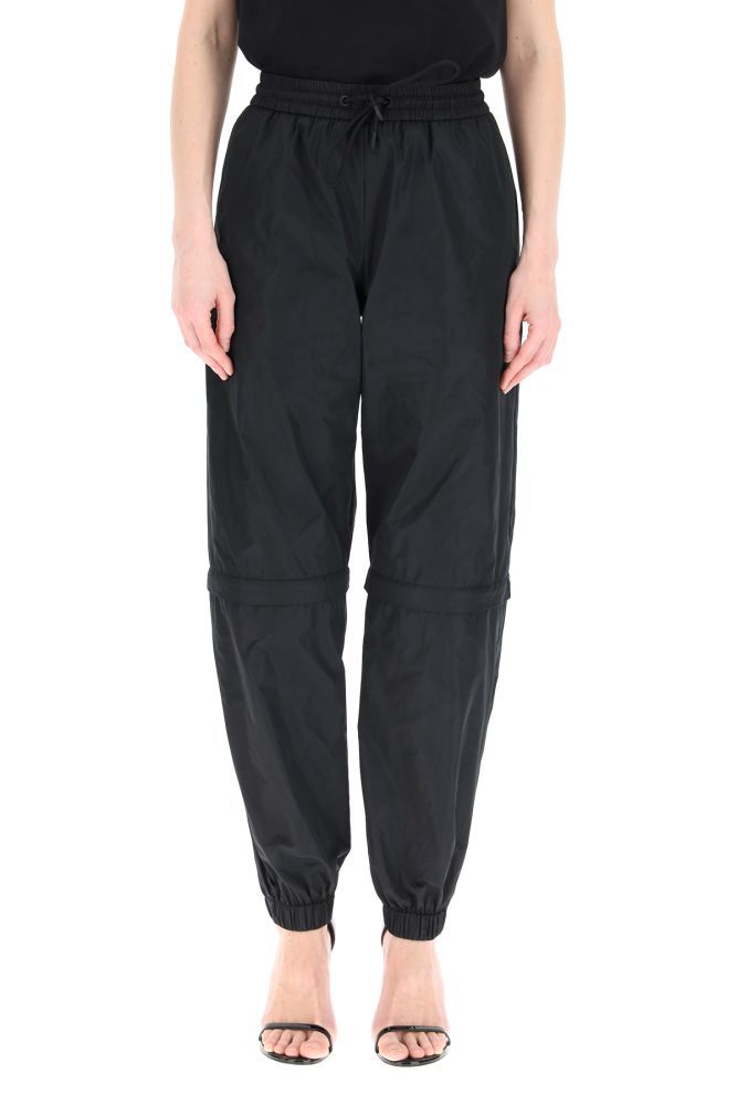 MSGM jogging trousers in polyester, featuring a zip at the knee which allows to detach the lower leg for a convertible look. Elasticated waist with drawstring, side inseam pockets, elasticated cuffs. The model is 177 cm tall and wears a size IT 38.
