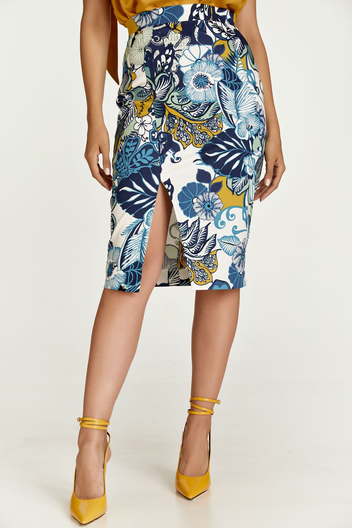 This pencil skirt is crafted in floral stretch gabardine fabric in blue and green shades. It has a 4cm wide waistband in the same fabric with darts below in the back. There is an off-centre slit in the front. It fastens in the back with a concealed zip. This pencil skirt is knee length and has an ecru lining. Heels and an off-shoulder top will take this skirt and you for a night on the town! This skirt is eco-friendly.
