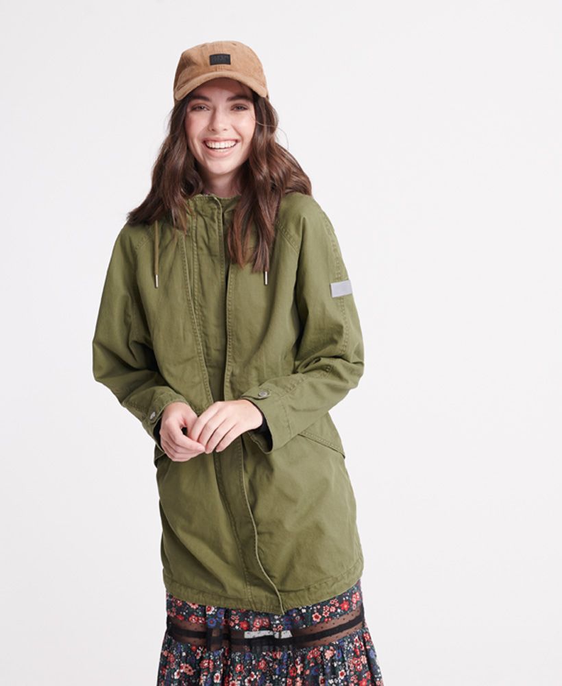 Superdry women's Adventurer Parka coat. This parka coat features, a drawstring hem, a zip and popper fastening, popper adjustable cuff, drawstring waist and hood, two front pockets, a jersey lining to the body and a batwing design to the front. Finished with Superdry branded poppers and zip pulls.