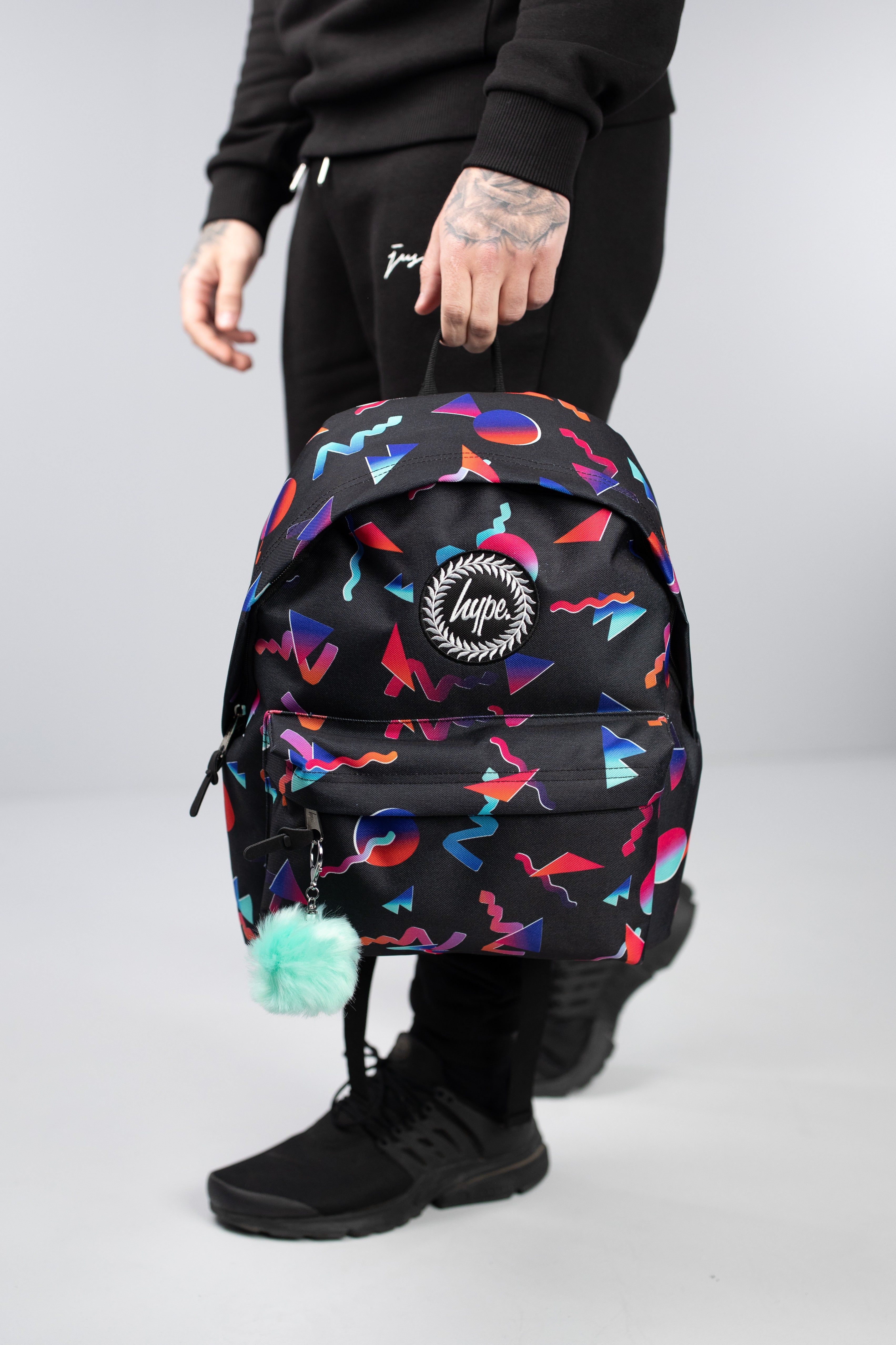 With a 90's throwback inspiration behind the bag, it's perfect to store your gym and dance kits. The HYPE. neon shapes backpack is designed with a black fabric base, with colour contrasting triangle, circle and zig-zag shapes in reds, pinks, oranges and blues. This backpack measures at 42cms x 30cms x 12cms, the right amount of room you require plus a lil' extra. The straps contain padding, creating the ultimate comfort. Wipe clean only.