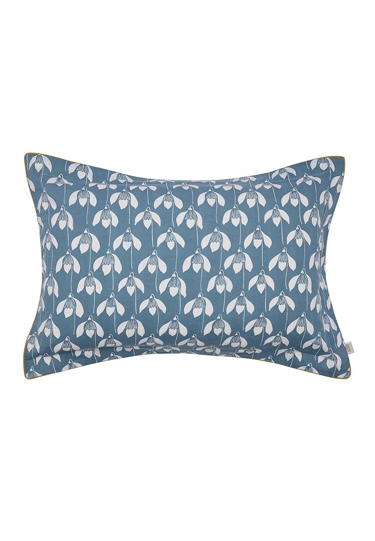 Snowdrop features an all-over stylised flower head set against a light blue ground. The design is reflected in a contrasting colourway on the reverse and finished with a grey piped edging. Printed on pure cotton, Snowdrop is available in four sizes of duvet cover sets which include a matching Oxford pillowcase(s). A textured cotton cushion featuring a bicycle print adds a quirky finishing touch. Made in Pakistan.
