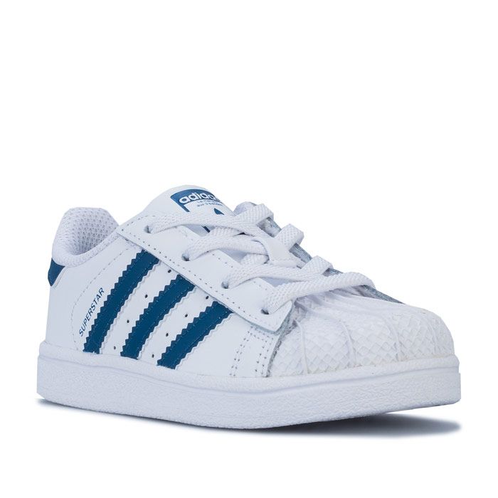 Infant Boys adidas Originals Superstar Trainers in footwear White - legend marine. – Smooth coated leather upper. – Elasticated lace closure for easy on-off. – Classic rubber shell toe. – Padded collar and tongue. – -3-Stripes to sides with printed ‘Superstar’ to side. – Printed Trefoil branding to tongue. – Contrast heel patch with printed Trefoil logo. – Comfortable textile lining. – Removable Ortholite sockliner for comfort and odour control. – Herringbone-pattern rubber cupsole. – Includes set of regular laces. – Leather and synthetic upper – Textile and synthetic lining – Synthetic sole. – Ref: F34165