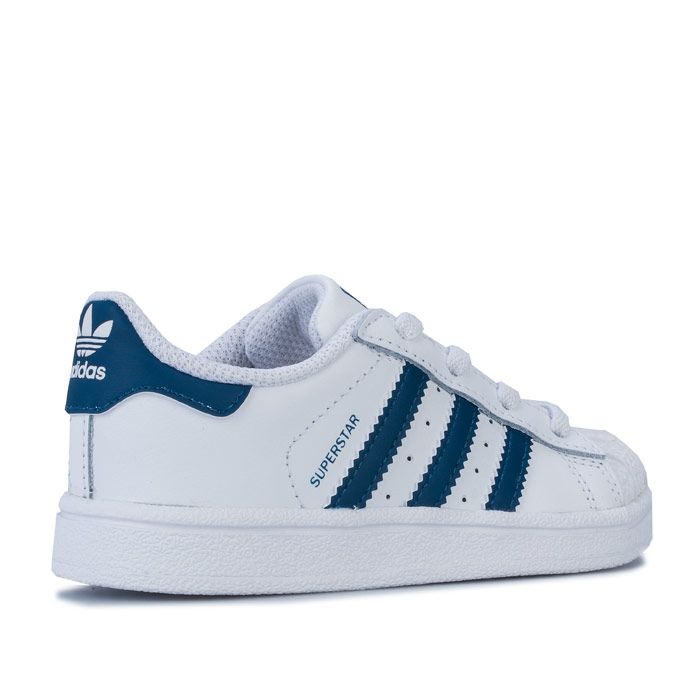 Infant Boys adidas Originals Superstar Trainers in footwear White - legend marine. – Smooth coated leather upper. – Elasticated lace closure for easy on-off. – Classic rubber shell toe. – Padded collar and tongue. – -3-Stripes to sides with printed ‘Superstar’ to side. – Printed Trefoil branding to tongue. – Contrast heel patch with printed Trefoil logo. – Comfortable textile lining. – Removable Ortholite sockliner for comfort and odour control. – Herringbone-pattern rubber cupsole. – Includes set of regular laces. – Leather and synthetic upper – Textile and synthetic lining – Synthetic sole. – Ref: F34165
