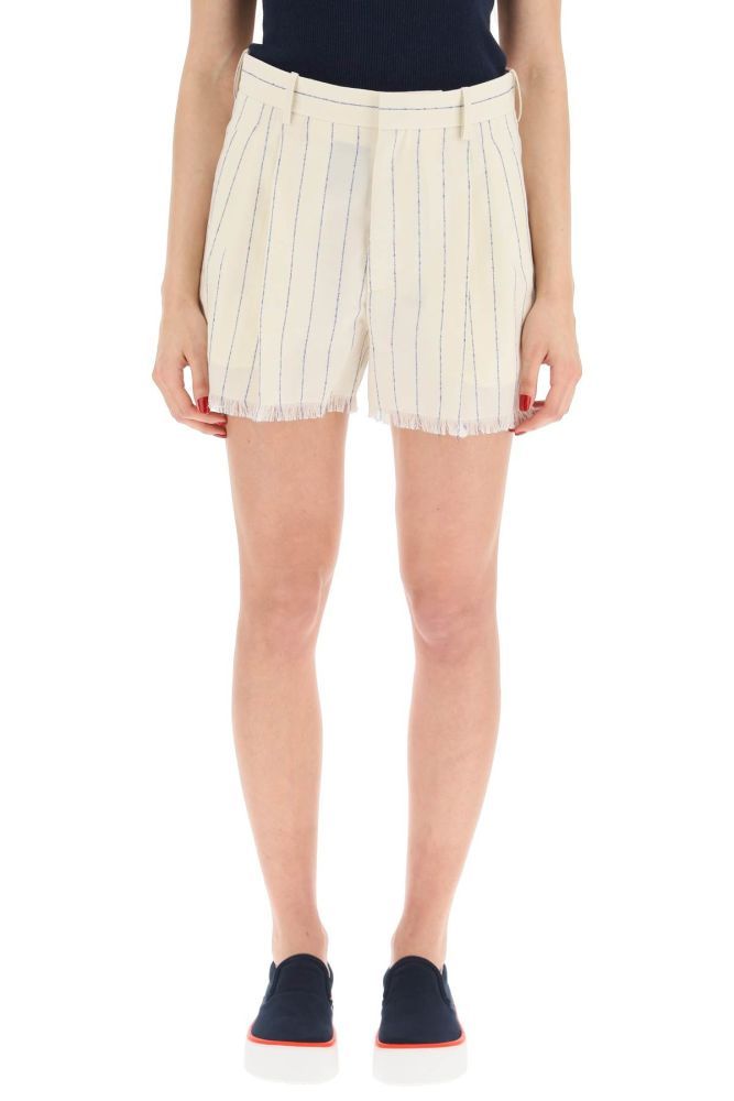 Marni short pants in pinstriped fresco wool characterized by concealed zip fastening with internal hook, welt pockets and one rear flap pocket with button. Frayed hem. Loose fit with long crotch. The model is 177 cm tall and wears a size IT 38.