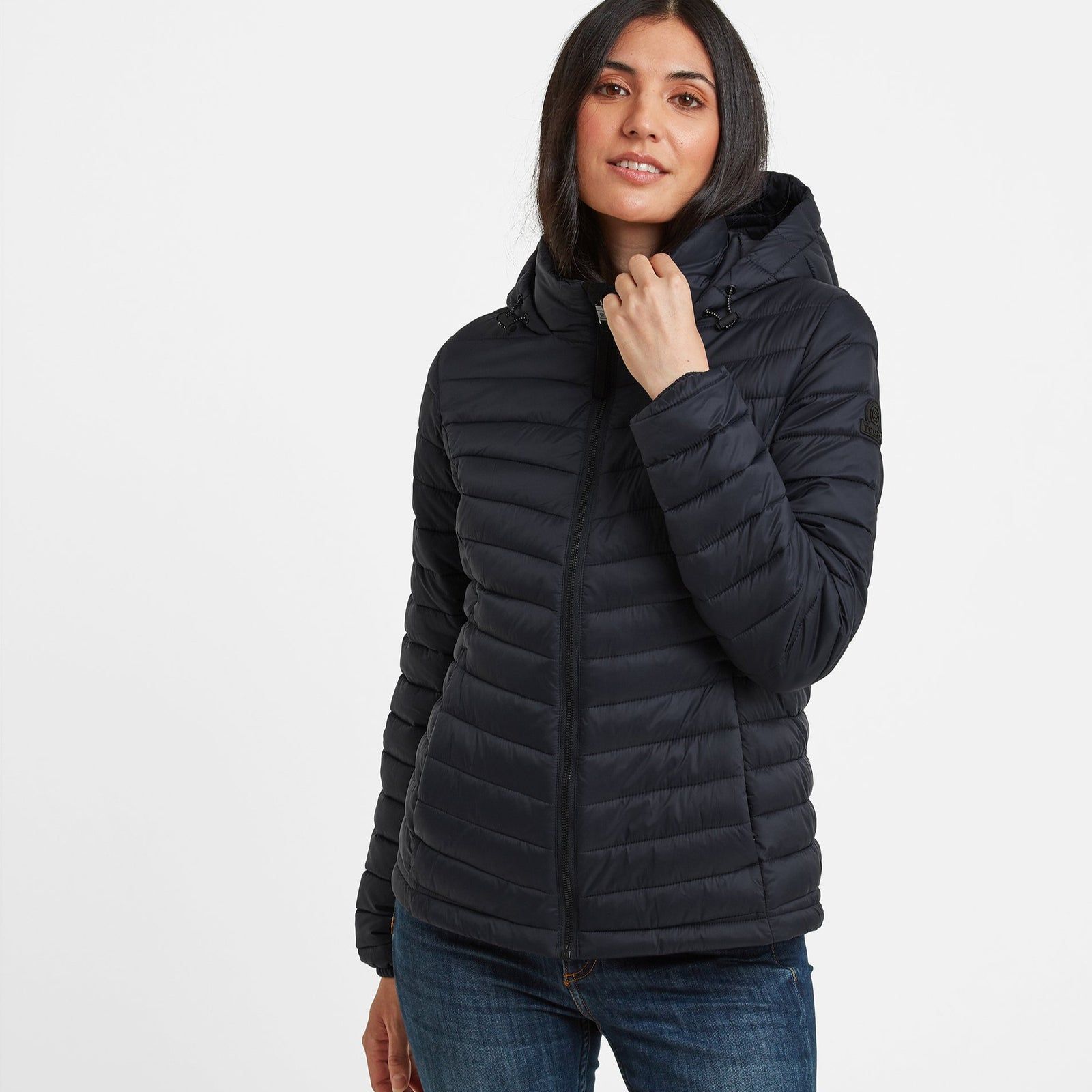 Lightweight, wind resistant and buttery soft, our Garriston quilted jacket gives you warmth without adding bulk and is designed in bold, chevron colour blocks inspired by moorland heather and the churning Atlantic sea. This distinctive and versatile jacket is perfect for travel as it squishes down small and springs back into shape when you need it. The thermal filling is made from recycled plastic bottles, so you'll be doing your bit to protect the environment too. Garriston has a cosy inner collar for added comfort and a fixed, insulated hood with toggle adjusters. There are two handy zip up pockets and a full length, easy pull zip at the front. The finishing touch is our iconic embossed rubber Yorkshire Rose badge on the sleeve.