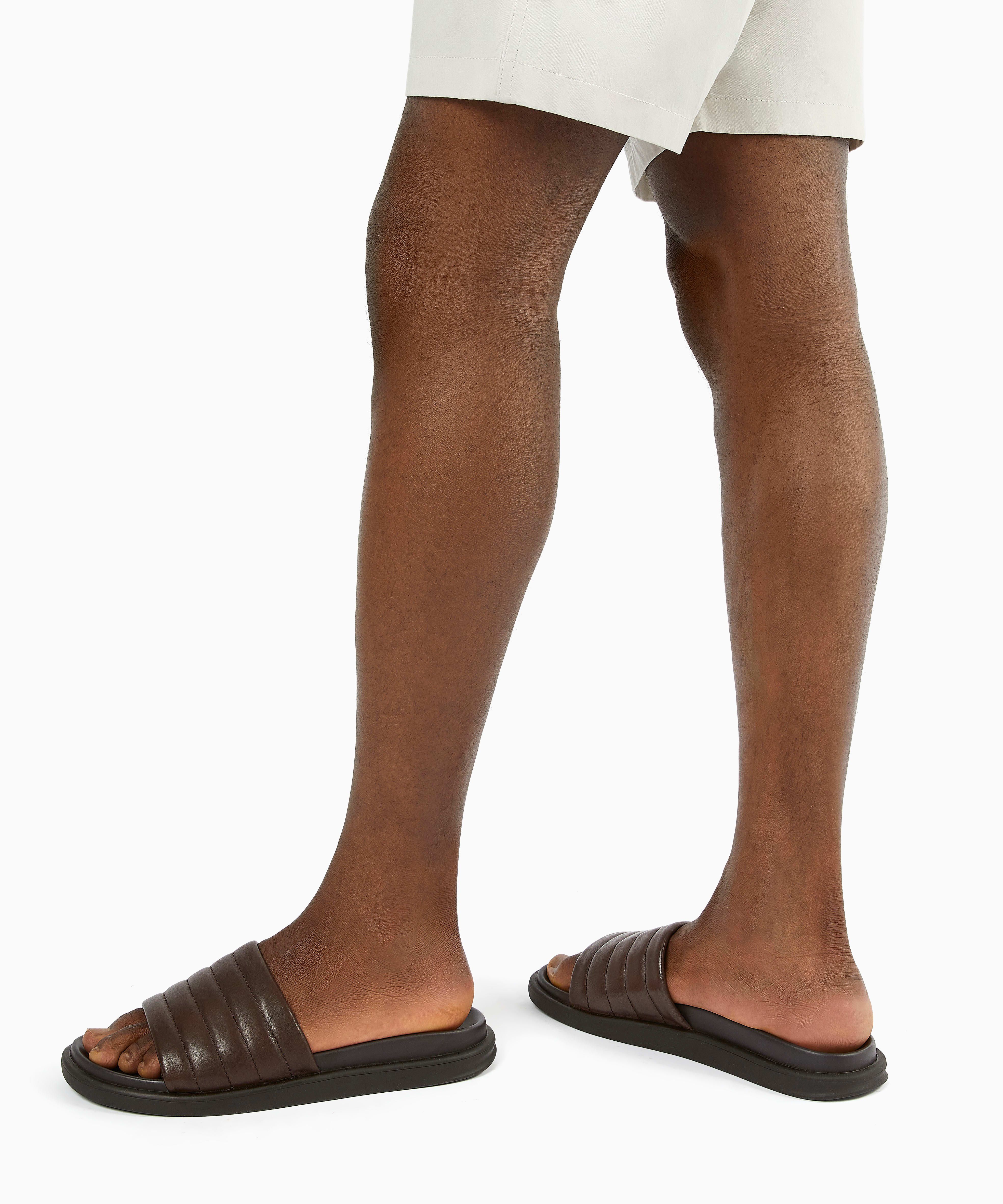 Sun-soaked destinations call for a pair of pool ready sliders. Comfortable and durable this must-have style has been designed in matte leather with padded straps and moulded footbeds.