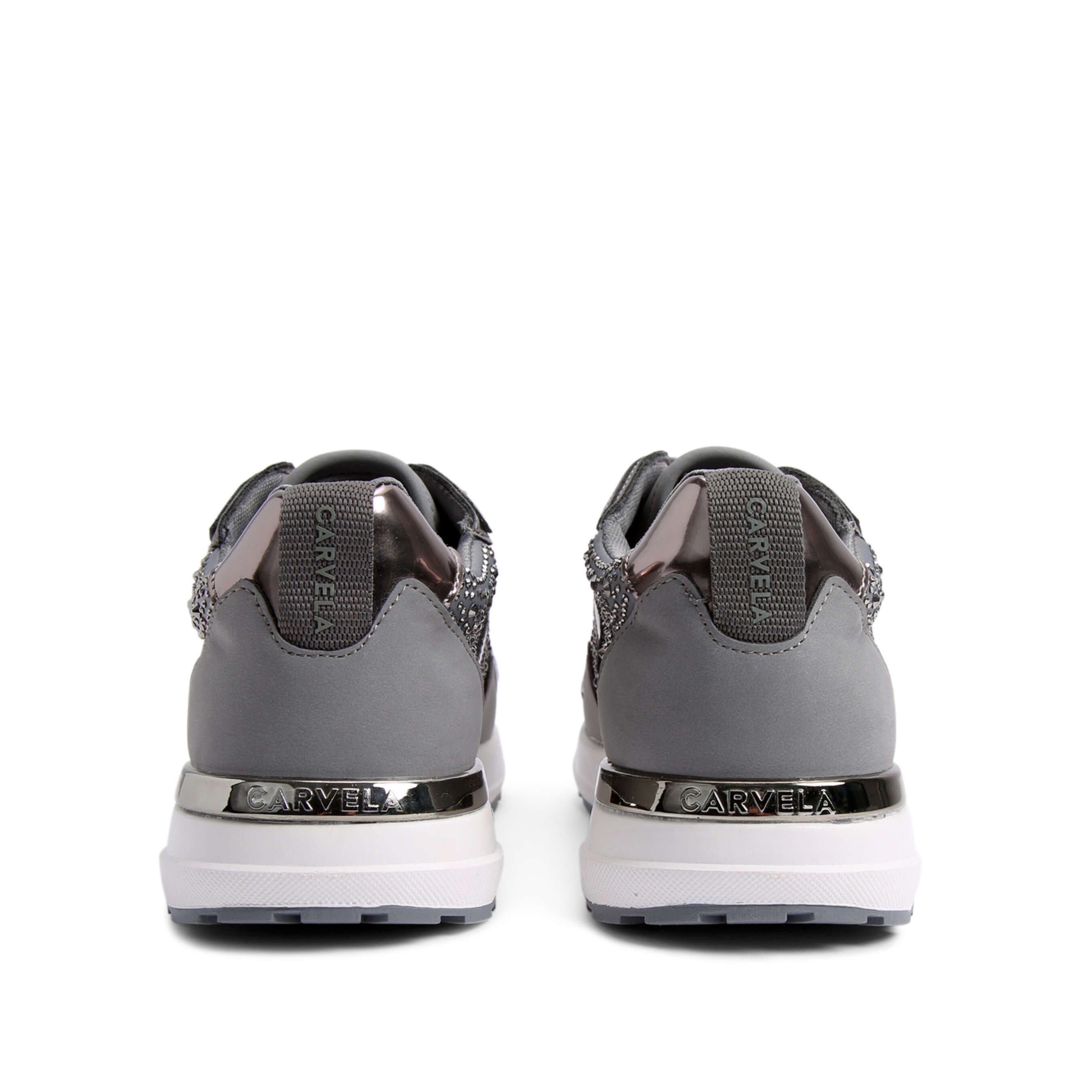 The Blink Jogger features a grey upper with crystal embellishment. There is a silver branded plate at the back of the ankle and the sole is in white.