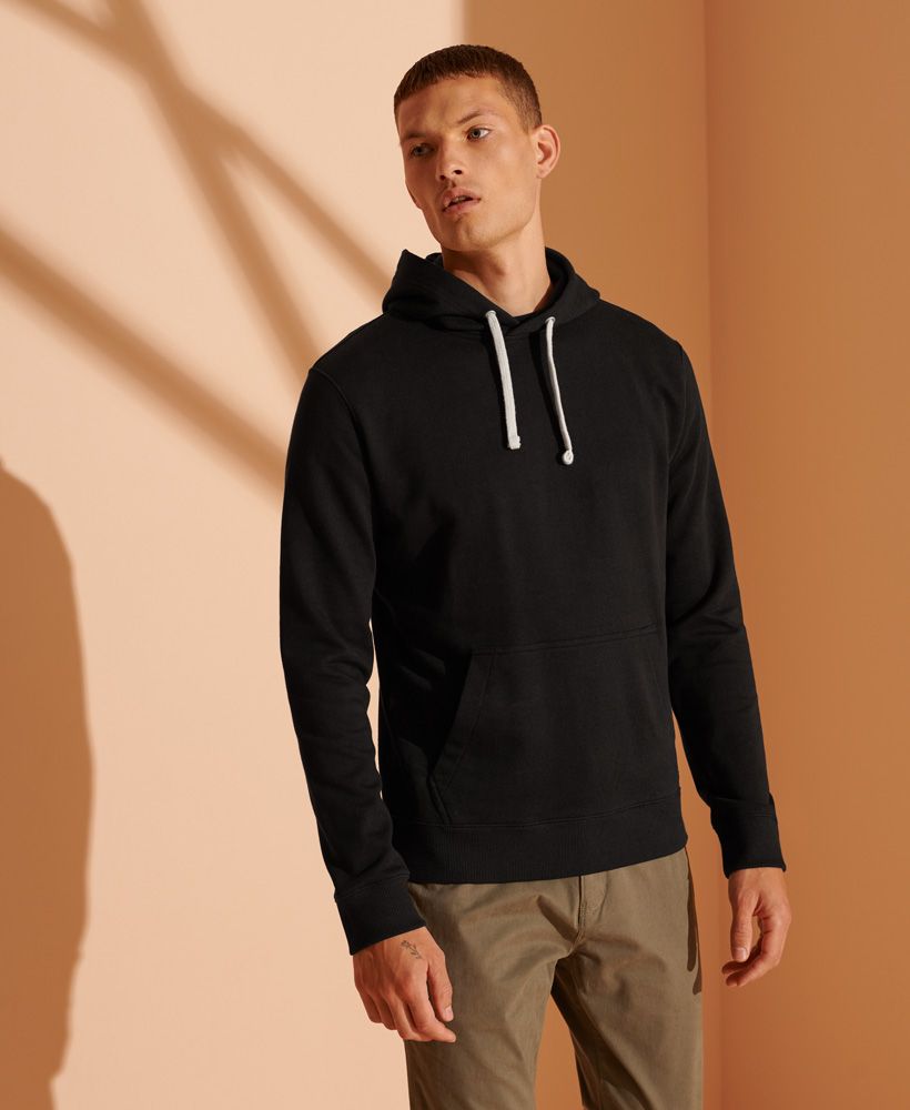 Simple, Sophisticated, Stylish. What more could you want in a hoodie? It's a classic 'throw on with any outfit' piece, guaranteed to make you look and feel amazing.Relaxed fit – the classic Superdry fit. Not too slim, not too loose, just right. Go for your normal sizeDrawstring hoodRibbed cuffs and hemFront pouch pocketSignature logo patchOrganic CottonMade with Organic Cotton - Grown using only organic inputs and no artificial chemicals, which leads to improved soil condition, stronger biodiversity and better health among the cotton growers and uses between 60-90% less water to grow. By 2030, all Superdry Cotton will be Organic.