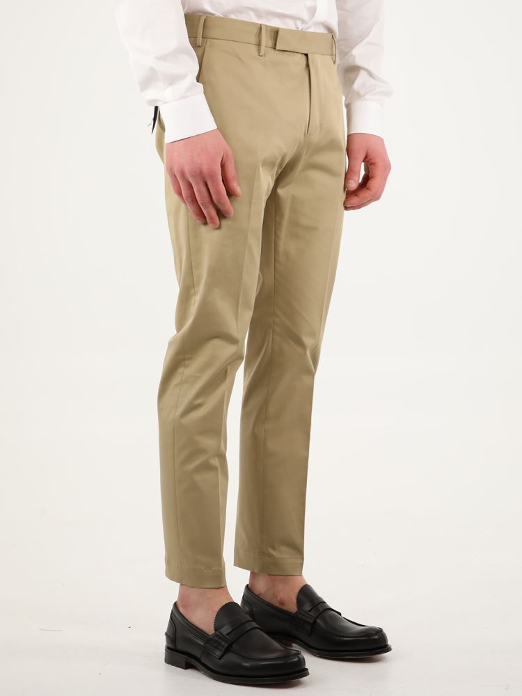 Dark beige cotton gabardine trousers with straight fit. They feature two side welt pockets, two rear pockets with button, rear charm and belt loops. The model is 184cm tall and wears size 48.  