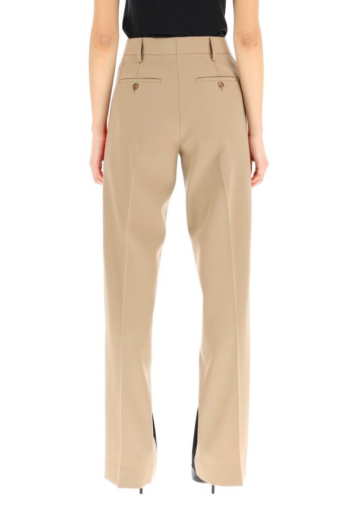 Burberry tailored trousers in grain de poudre wool with a straight cut, enhanced by a color-block design inspired by signature Icon Stripe motif. Concealed zip and hook closure, belt loops, side slip pockets, back button-through welt pockets. The model is 177 cm tall and wears a size UK 6.