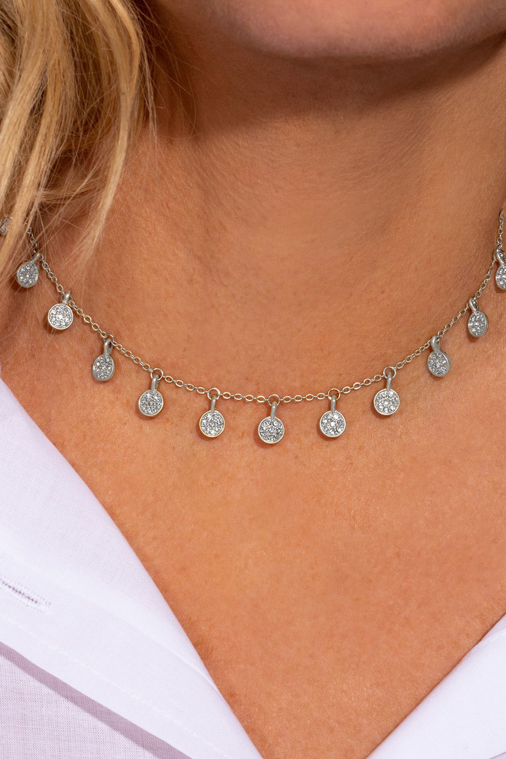 If you love your boho jewellery with a sparkly twist, this choker necklace has your name all over it! It features a dainty silver choker with miniature coins that dance across your neck. The silver plated necklace features pavé detailing with sparkling clear stones and it's perfect for layering with another longer necklace with a low neckline outfit, or over the top of a jumper during the day! It measures 15 inches and comes with a lobster clasp fastening and a 3 inch extender. The Boho pave choker necklace is designed as a laid back piece with a glamorous twist that you can wear with so many looks!
• Necklace measures 15 inches with a 3 inch extender
• Presented in a stylish KTx jewellery pouch