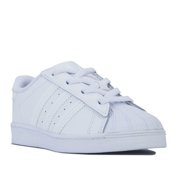 Infant adidas Originals Superstar Trainers in footwear White. – Smooth coated leather upper. – Elasticated lace closure for easy on-off. – Classic rubber shell toe. – Padded collar and tongue. – Tonal 3-Stripes to sides and printed ‘Superstar’ wordmark. – Tonal print Trefoil branding to tongue. – Tonal heel patch with embossed Trefoil logo. – Comfortable textile lining. – Removable Ortholite sockliner for comfort and odour control. – Herringbone-pattern rubber cupsole. – Includes set of regular laces. – Leather and synthetic upper – Textile lining – Synthetic sole. – Ref: EF5397