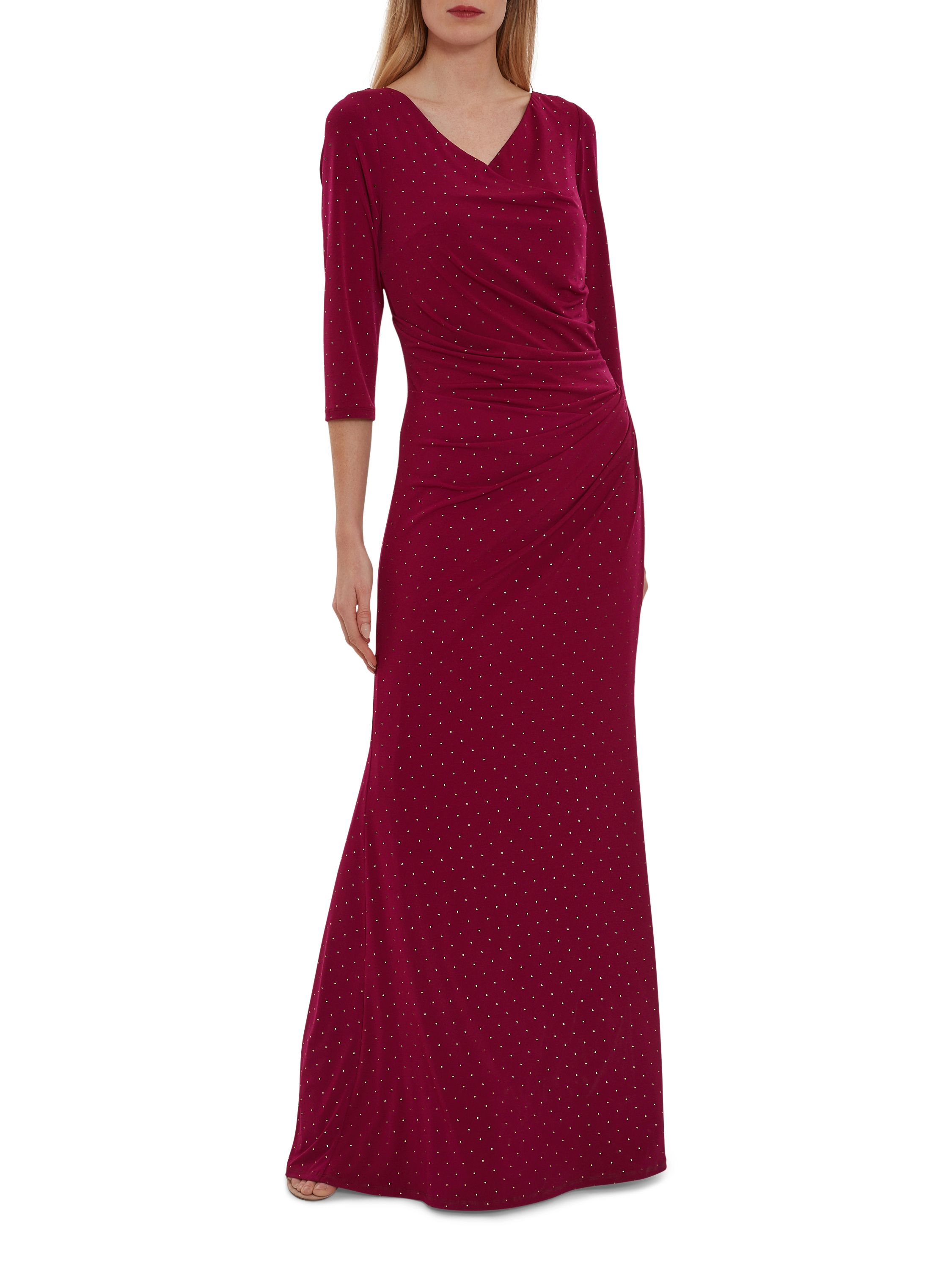 This maxi dress by Gina Bacconi is a showstopper of a piece. This piece is fashioned from a luxuriously soft jersey fabric with stud detailing which gracefully wraps over the bodice and ruches at the side of the waist. The asymmetric drape of the dress offers you a flawless silhouette. This dress is fully lined for extra comfort and fastens using a concealed centre back zip.