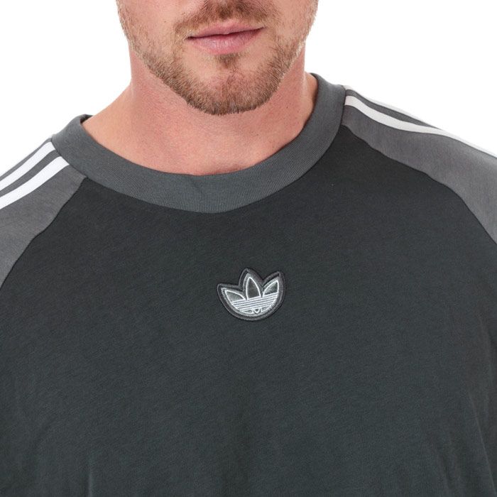 Mens adidas Originals SPRT Football T-Shirt in carbon - grey five.<BR><BR>- Ribbed crew neck.<BR>- Short raglan sleeves.<BR>- Applied 3-Stripes at shoulders and sleeves.<BR>- Contrast sleeve overlays with Trefoil branding.<BR>- Embroidered Trefoil logo patch at centre chest.<BR>- Contrast back neck tape.<BR>- Regular fit.<BR>- Main material: 100% Cotton.  Machine washable.<BR>- Ref: FK1976