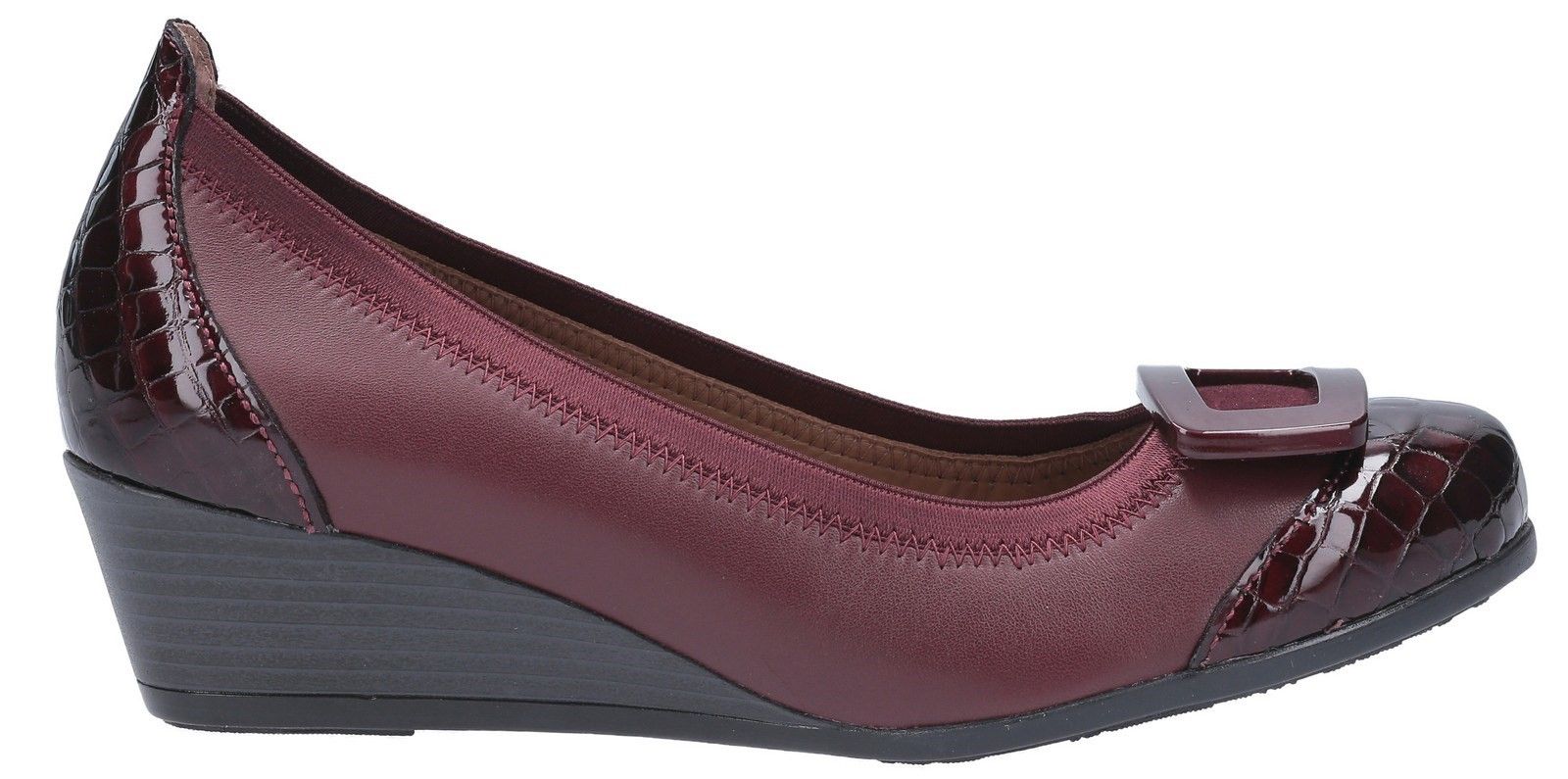 RIVA has built its reputation on resolutely classic Italian style.. with a twist. These luxury slip on formal court shoes highlight patent overlays, a wedge heel and a stylish large open square feature.Women's luxury slip on wedge court in formal design. 
Crafted with a full grain leather upper with comfortable rounded toe. 
Features a smooth patent toe cap and heel overlay. 
Slip on style with elasticated opening for fitting. 
Stylish large open square feature on front toe.